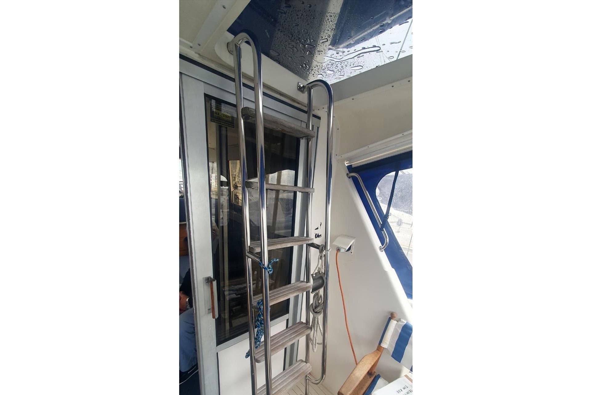 Interior of 1989 Princess 35 boat with metal ladder and window view.