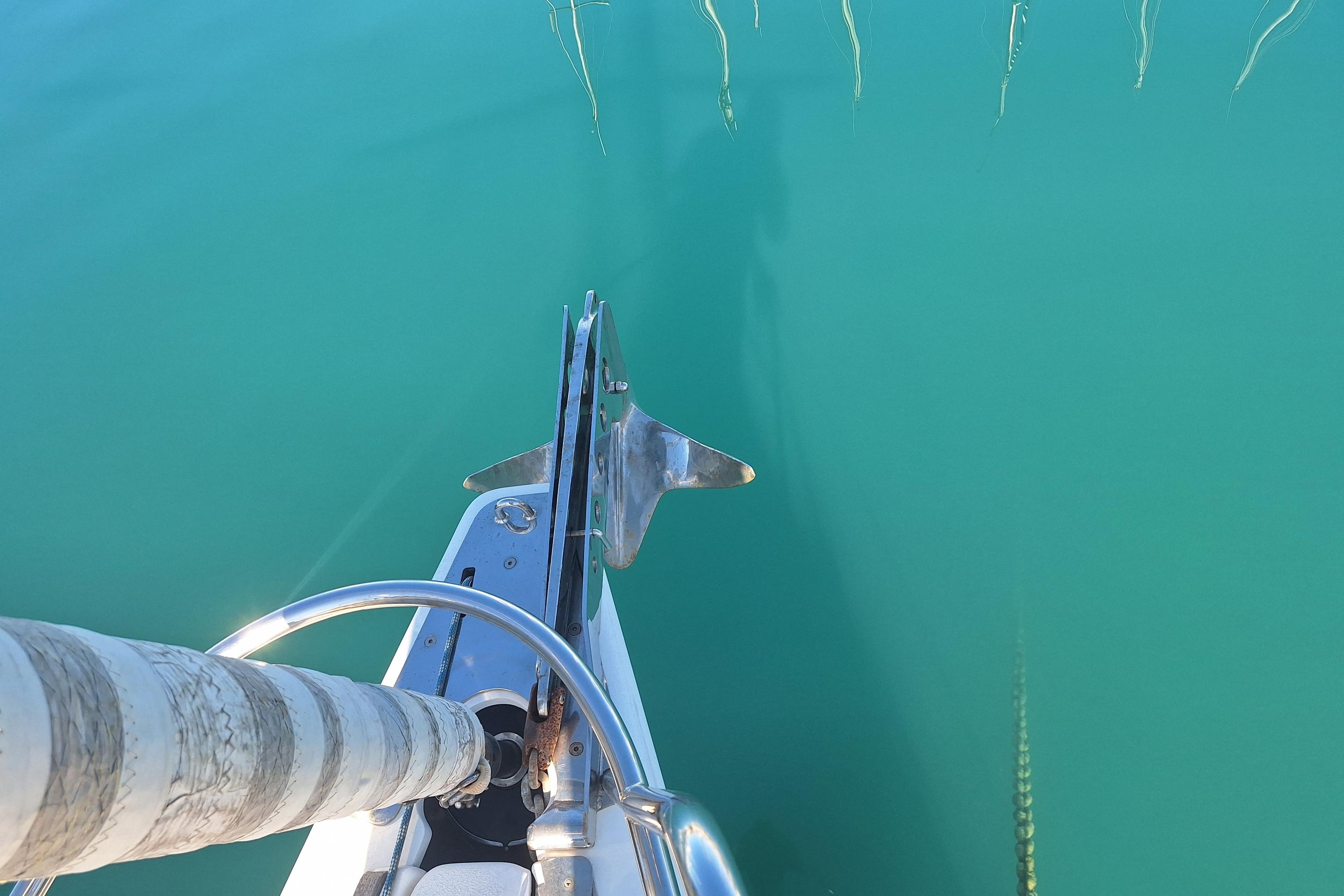 Bow of 2006 X-Yachts X-43 sailboat with anchor over turquoise water.