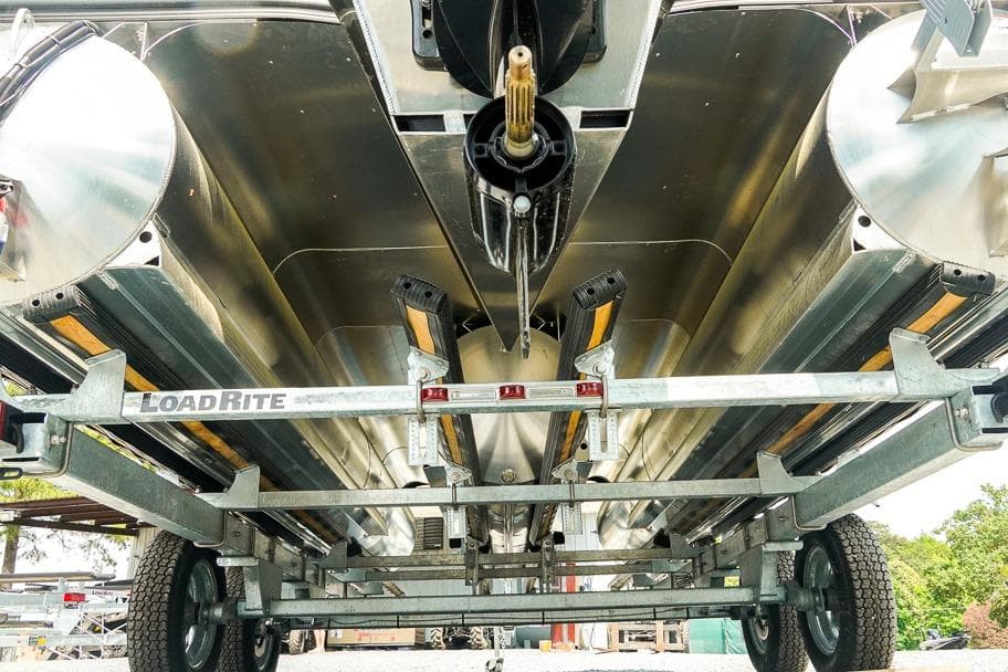 Underneath view of a 2026 Dockside 22DF boat on a LoadRite trailer.