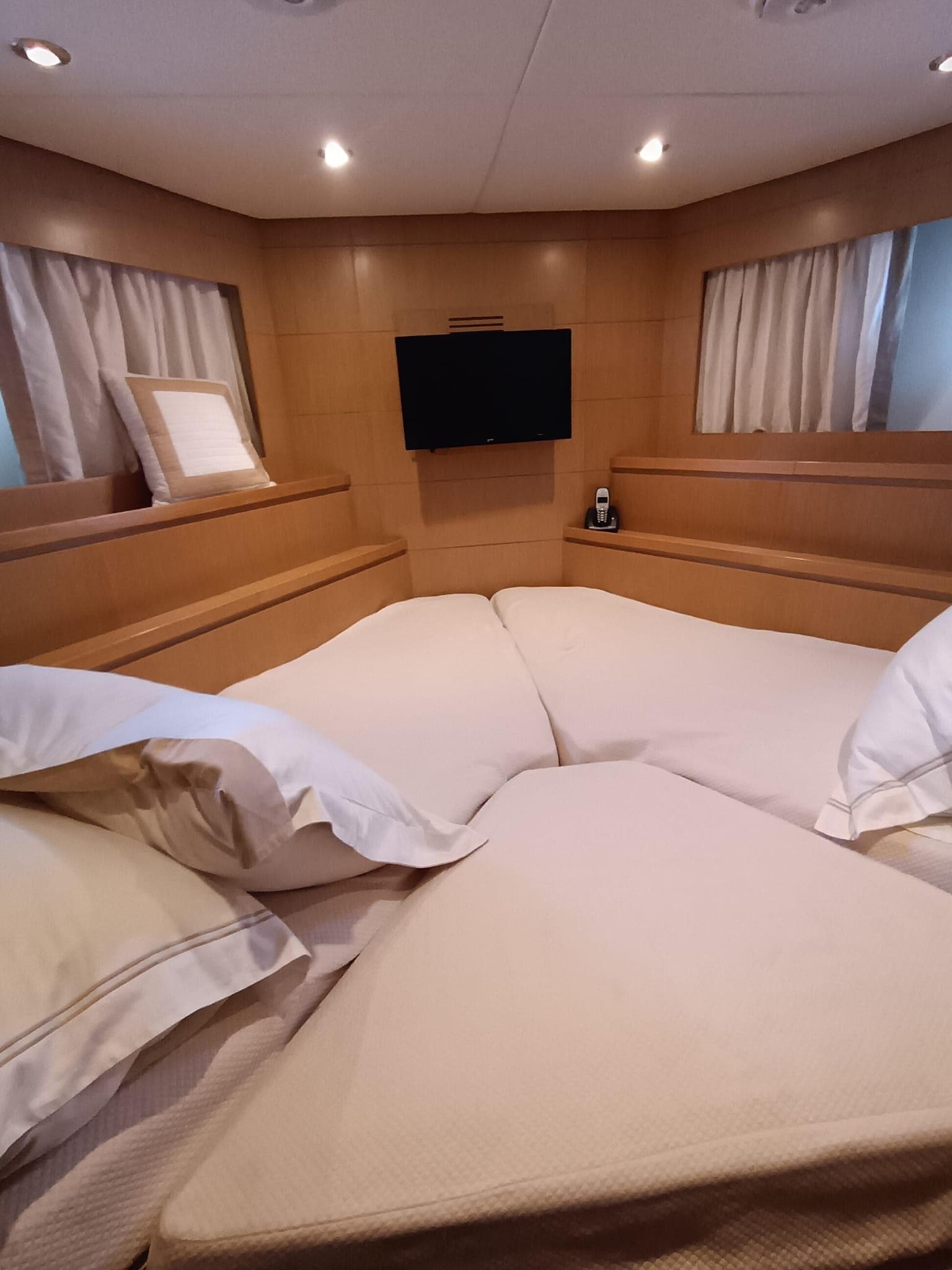 Luxurious cabin interior of 2007 Grand Banks 59 Aleutian RP yacht with cozy bedding.
