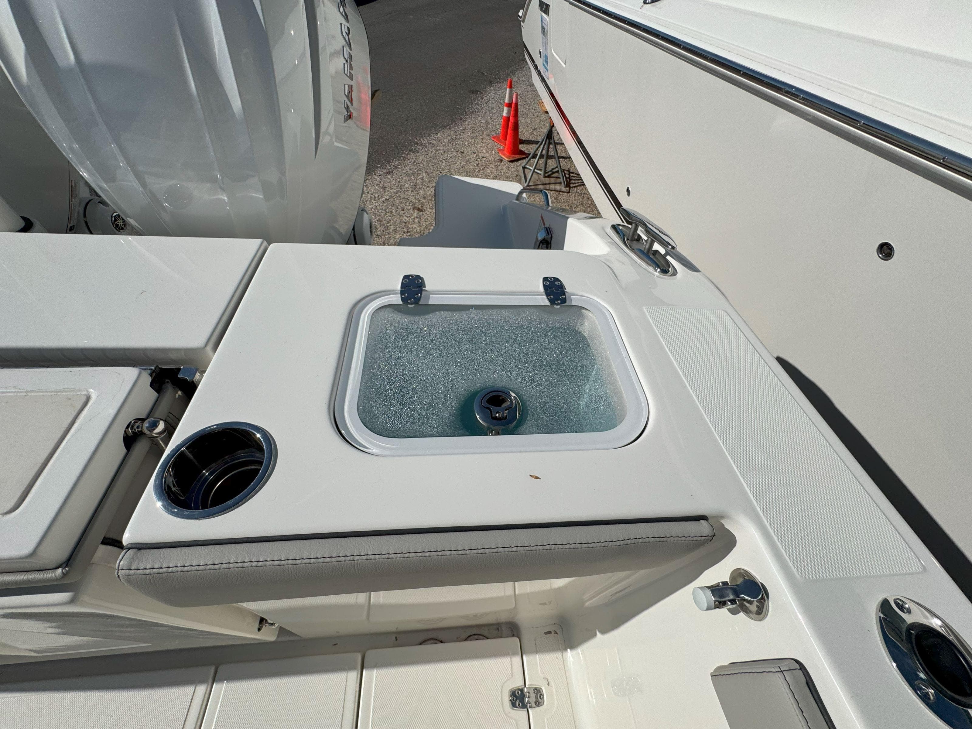 2025 Pursuit S 328 boat deck with livewell and cup holder.