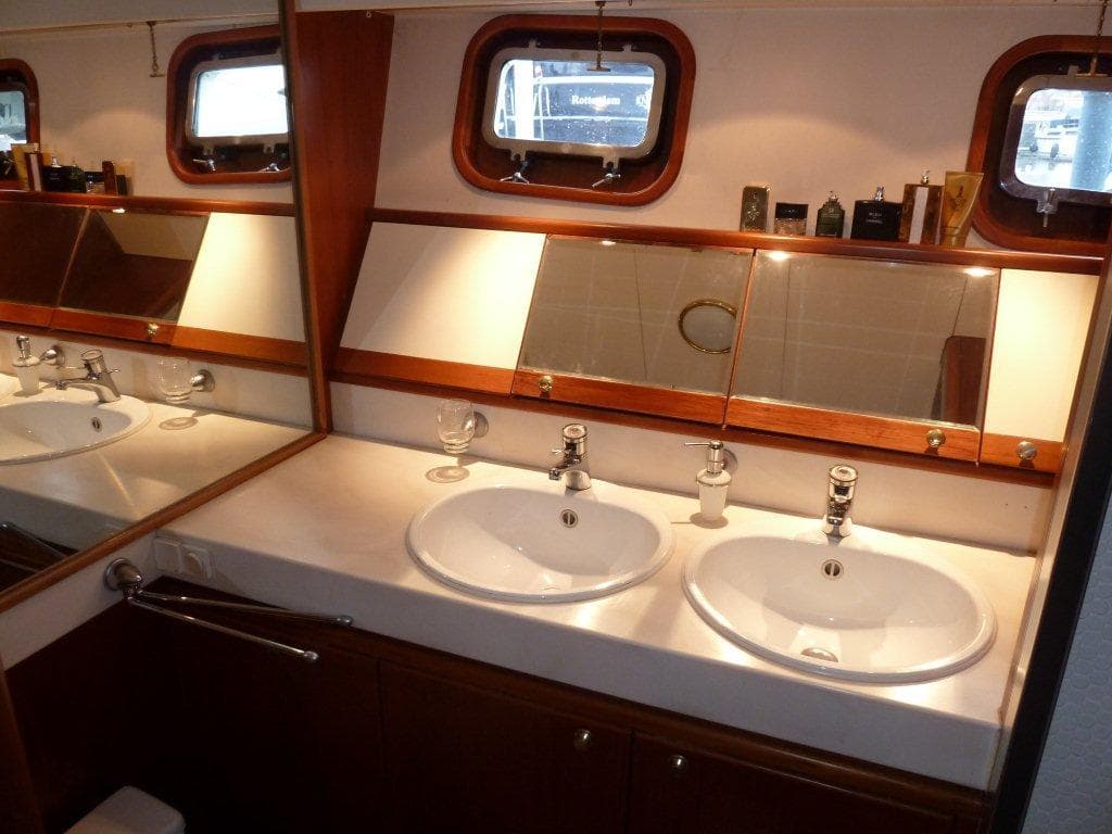 Luxury bathroom with dual sinks in a 1987 Moonen 72 yacht.