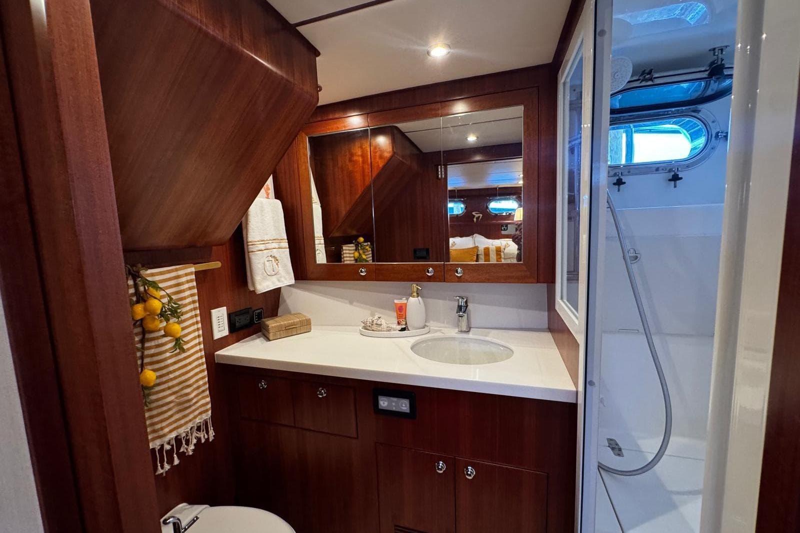 Luxurious bathroom in 2025 Nordhavn 475 yacht with wood accents and modern fixtures.