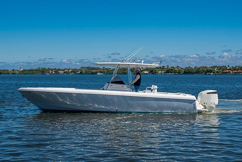 2005 Intrepid 300 Center Console boat cruising on a sunny day.