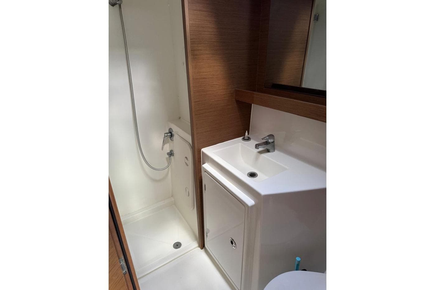 Modern bathroom in 2018 Lagoon 42 yacht with shower and sink.