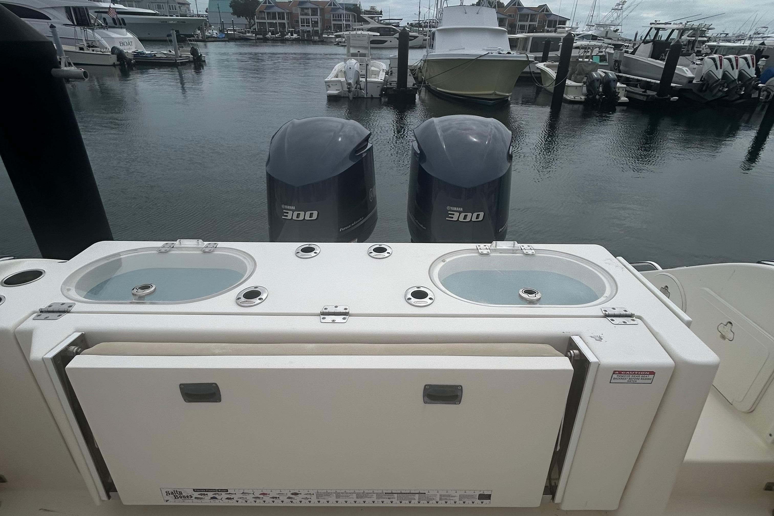 2016 Cobia 296 Center Console boat with dual Yamaha 300 engines at marina.