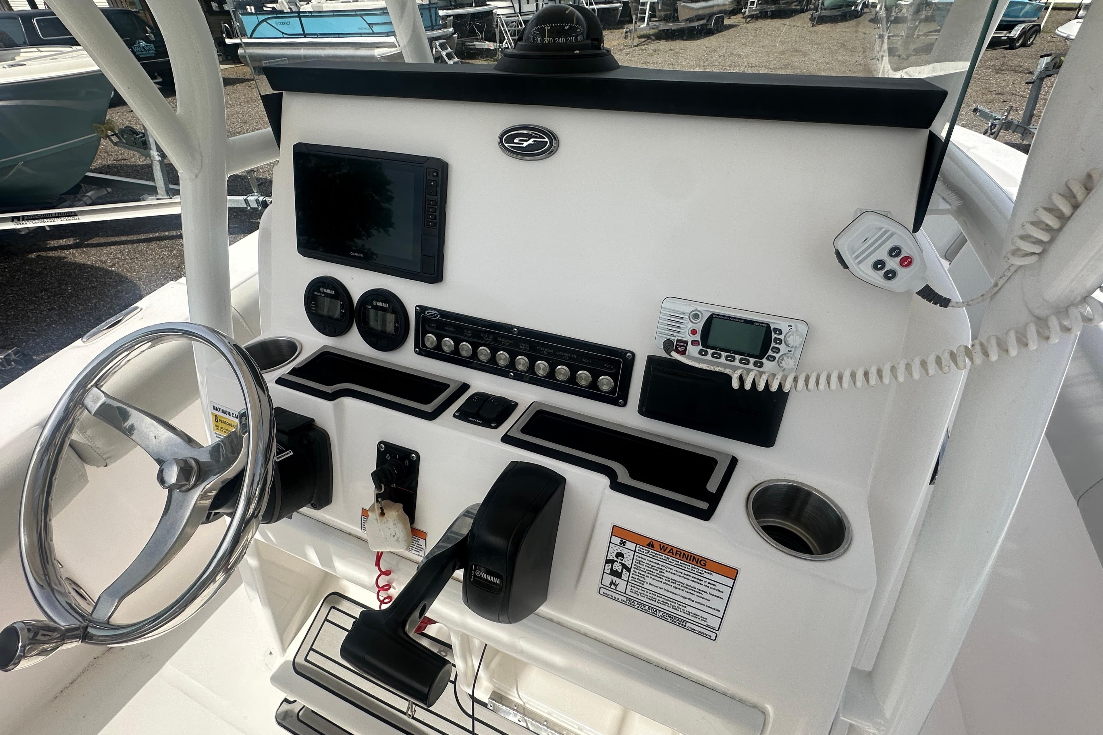 2023 Sea Fox 228 Commander boat dashboard with steering wheel and electronic controls.