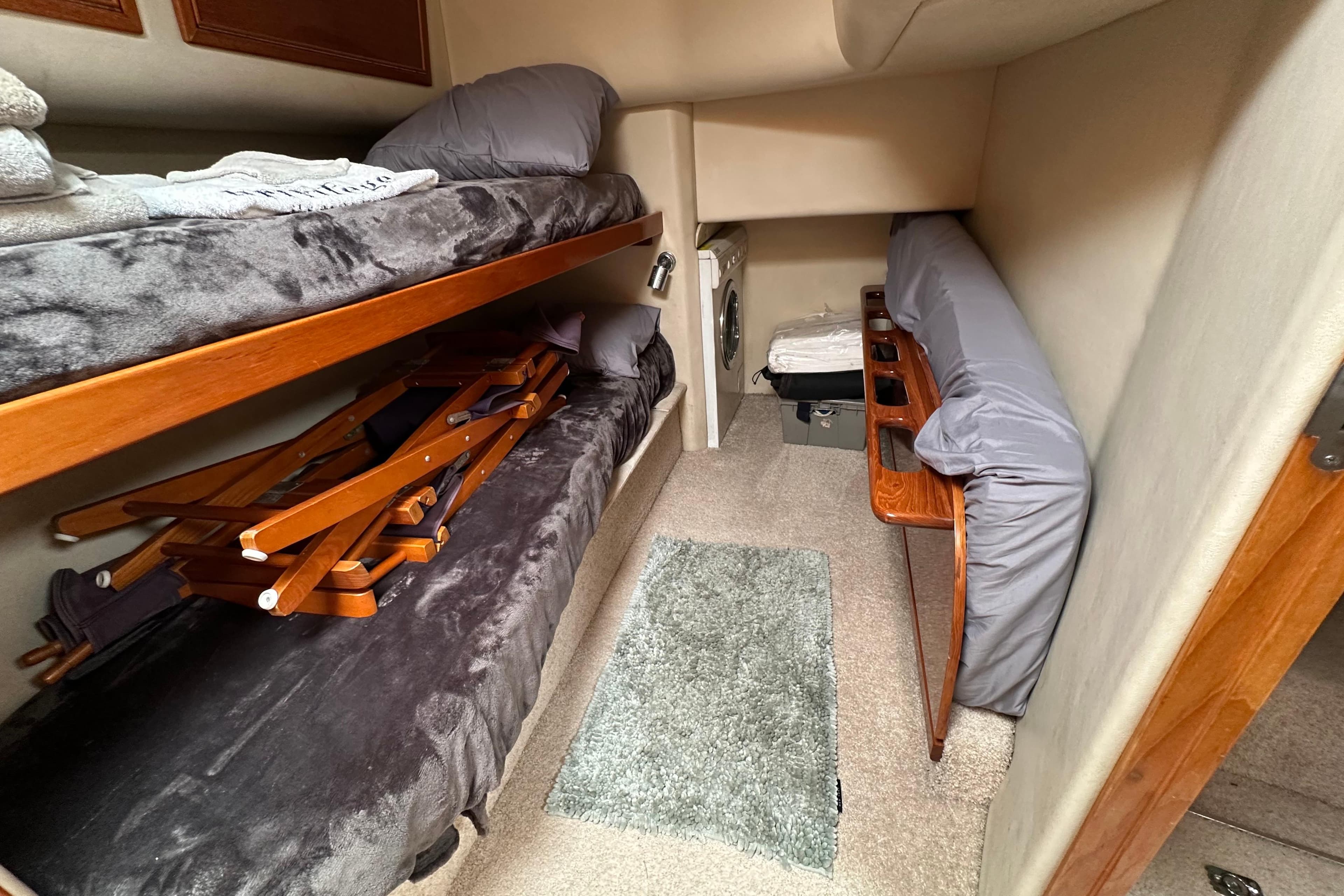 Interior cabin of 2002 Riviera 40 Flybridge with bunk beds and storage.