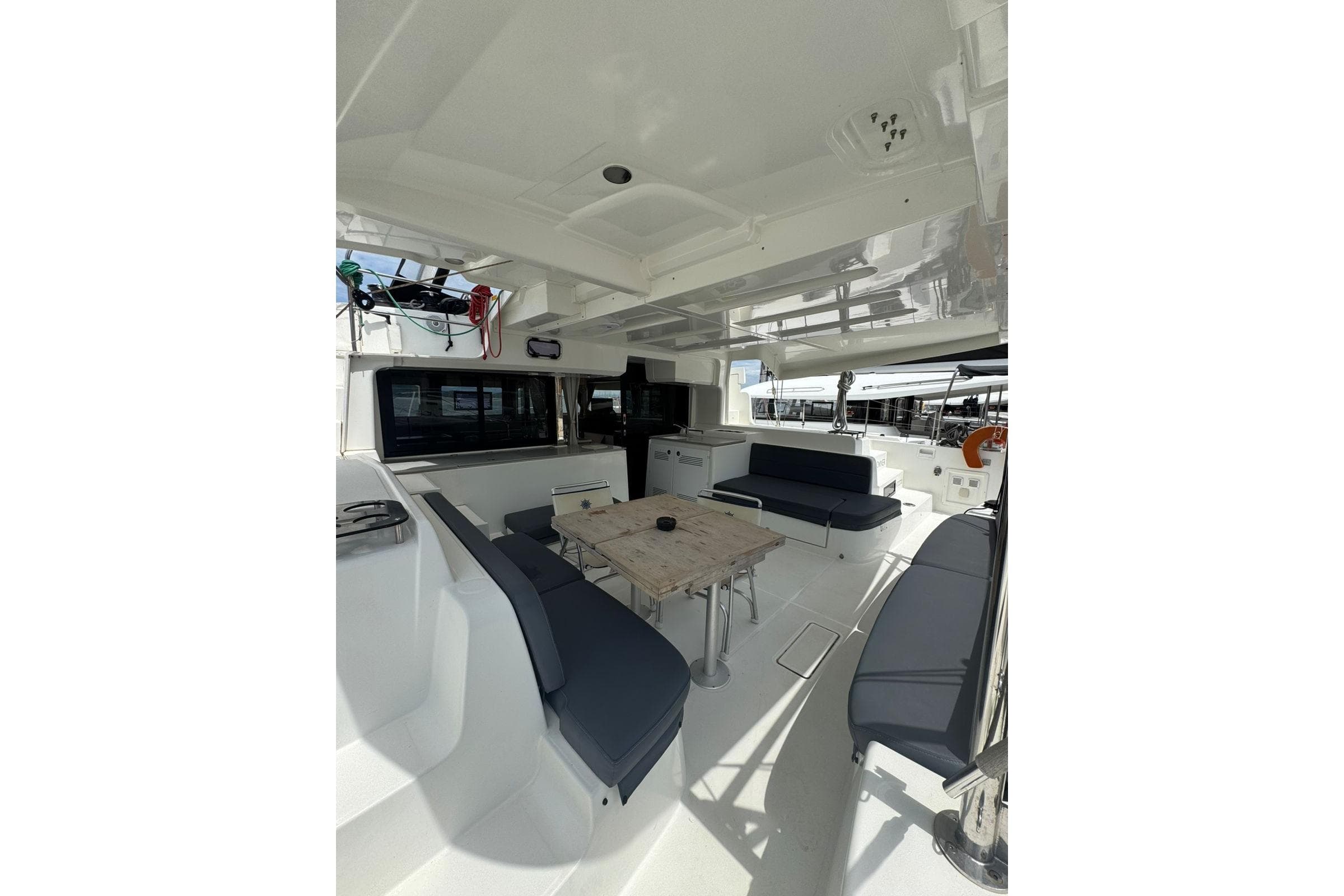 Spacious 2021 Lagoon 46 catamaran cockpit with seating and dining area.