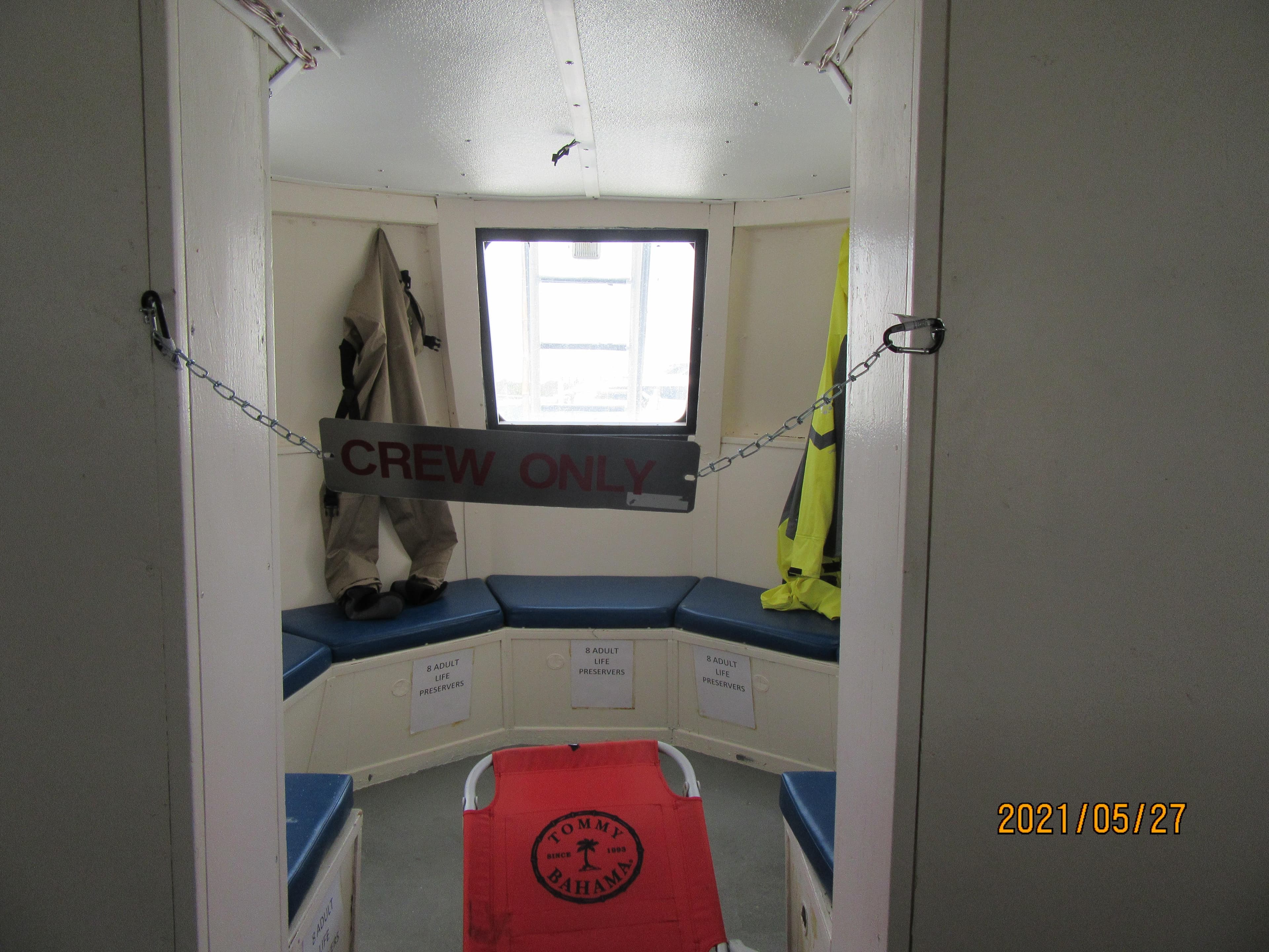 Interior of 1986 Drift Fishing Party boat, crew-only area with seating and safety gear.