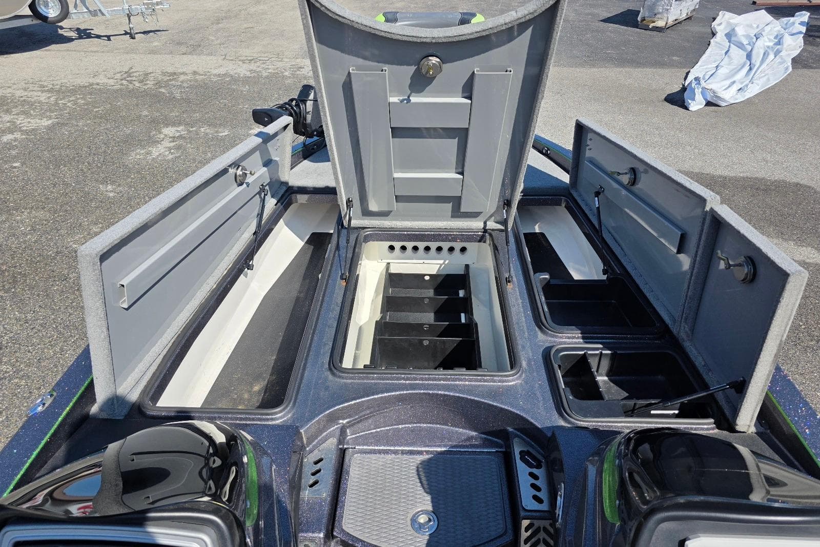 2022 Caymas CX 21 boat storage compartments open, showcasing organized interior layout.