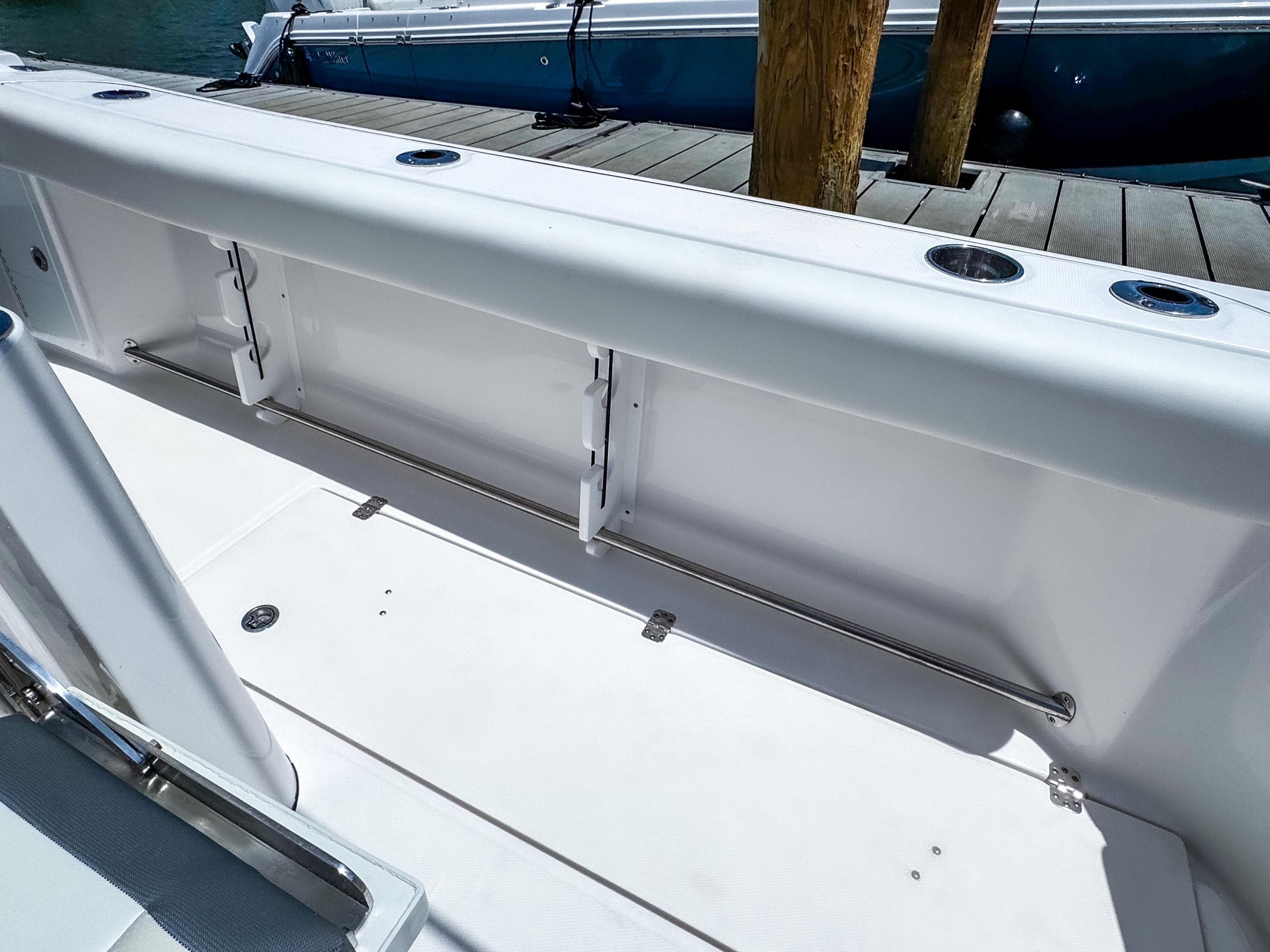 2025 Edgewater 370CC boat deck with rod holders and storage compartments.