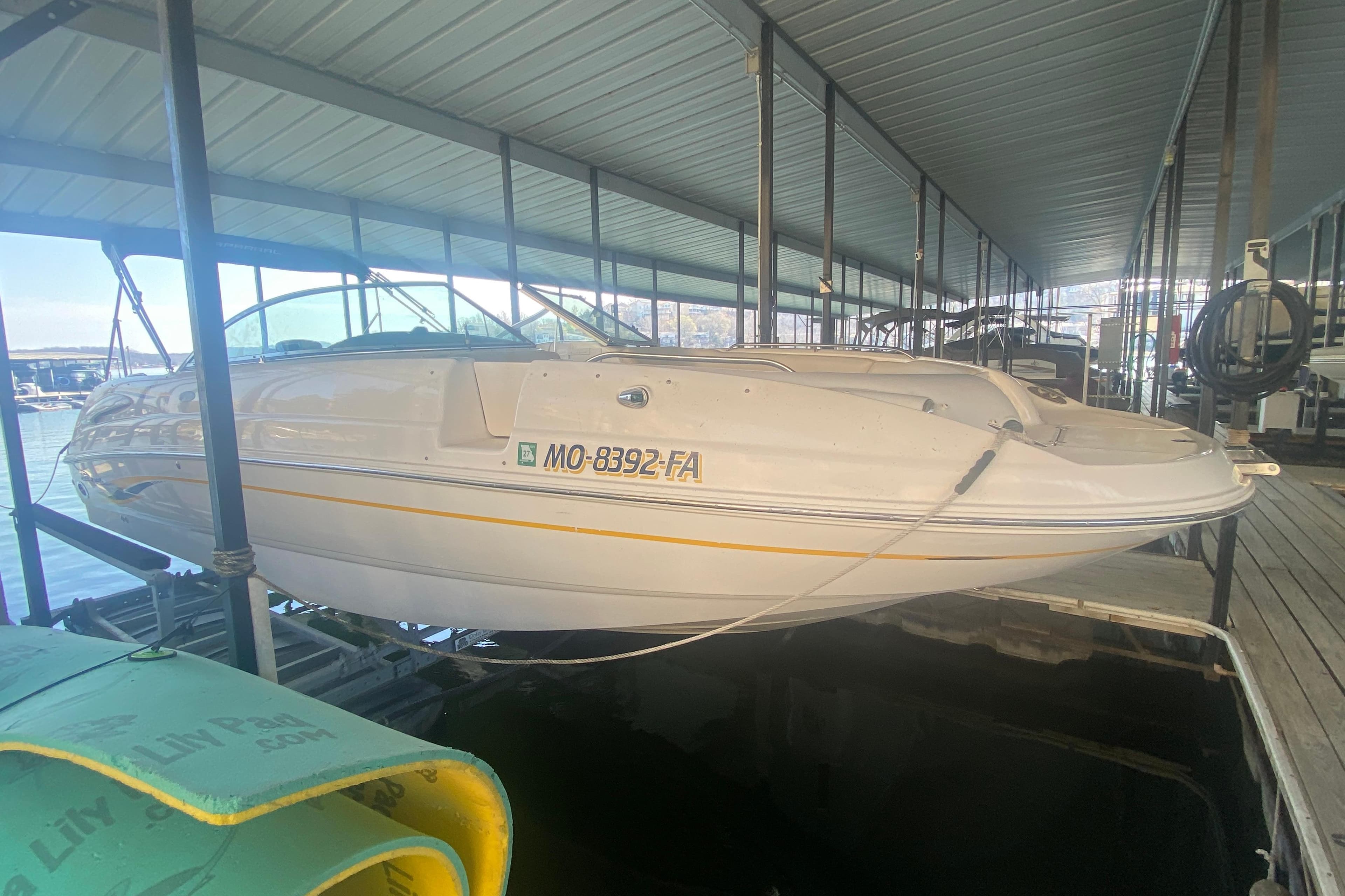 2003 Chaparral Sunesta 263 boat docked in covered marina.