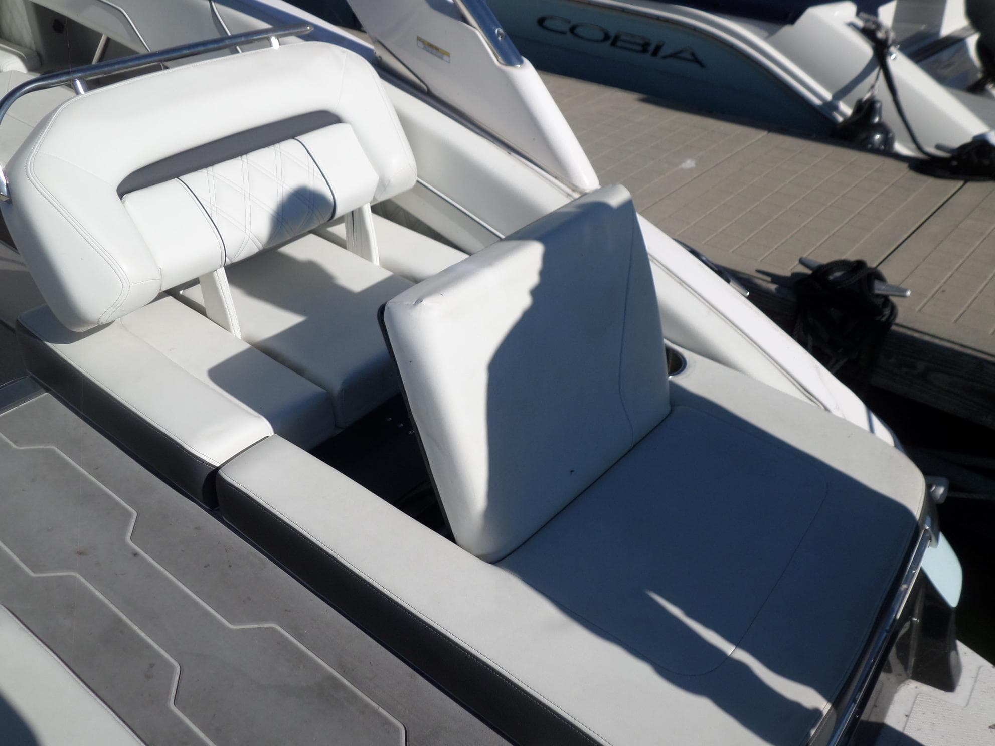 2020 Regal LS6 boat with white leather seating on a sunny dock.