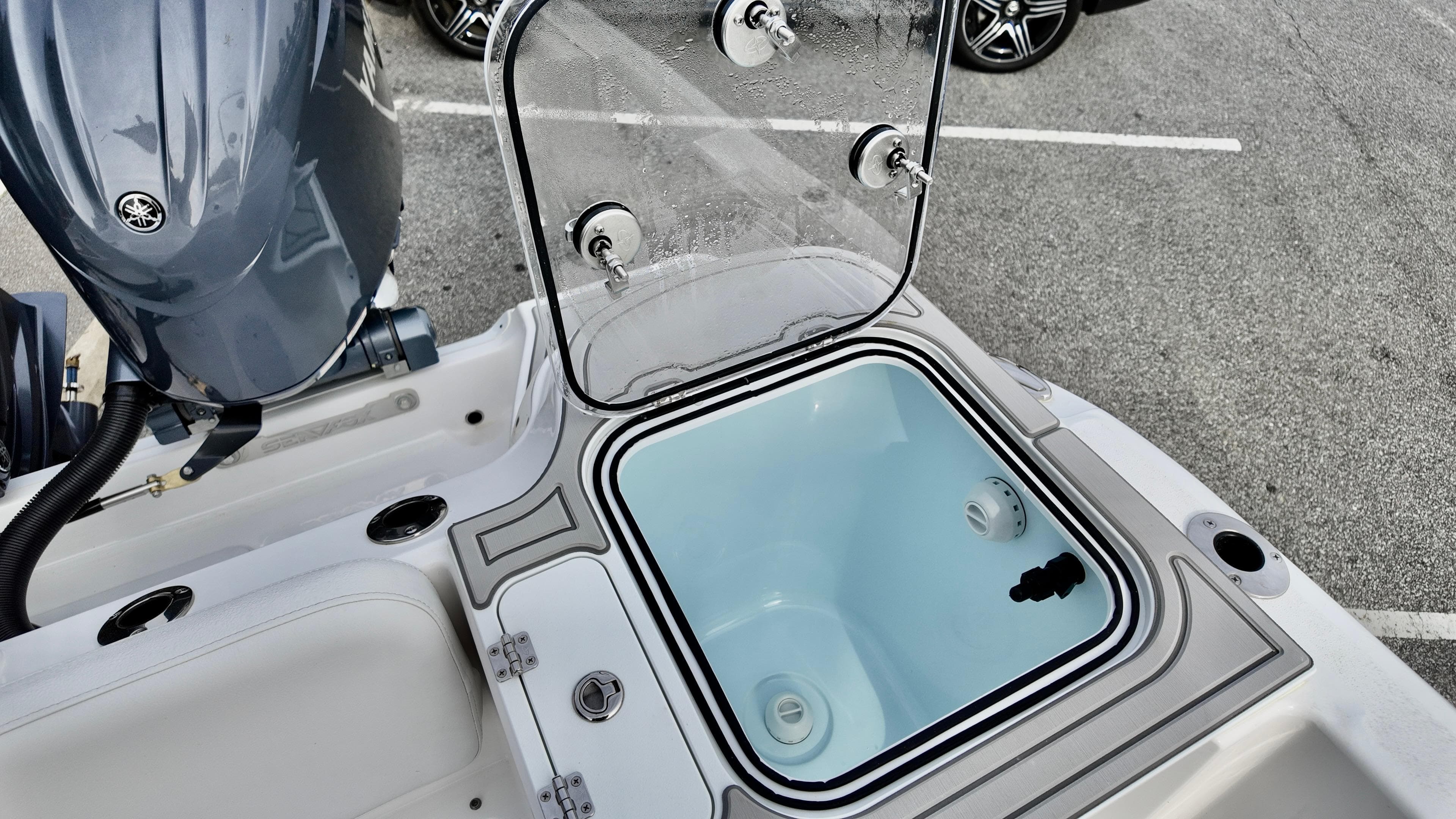 2025 Sea Fox 268 Commander boat with open storage compartment and visible engine.