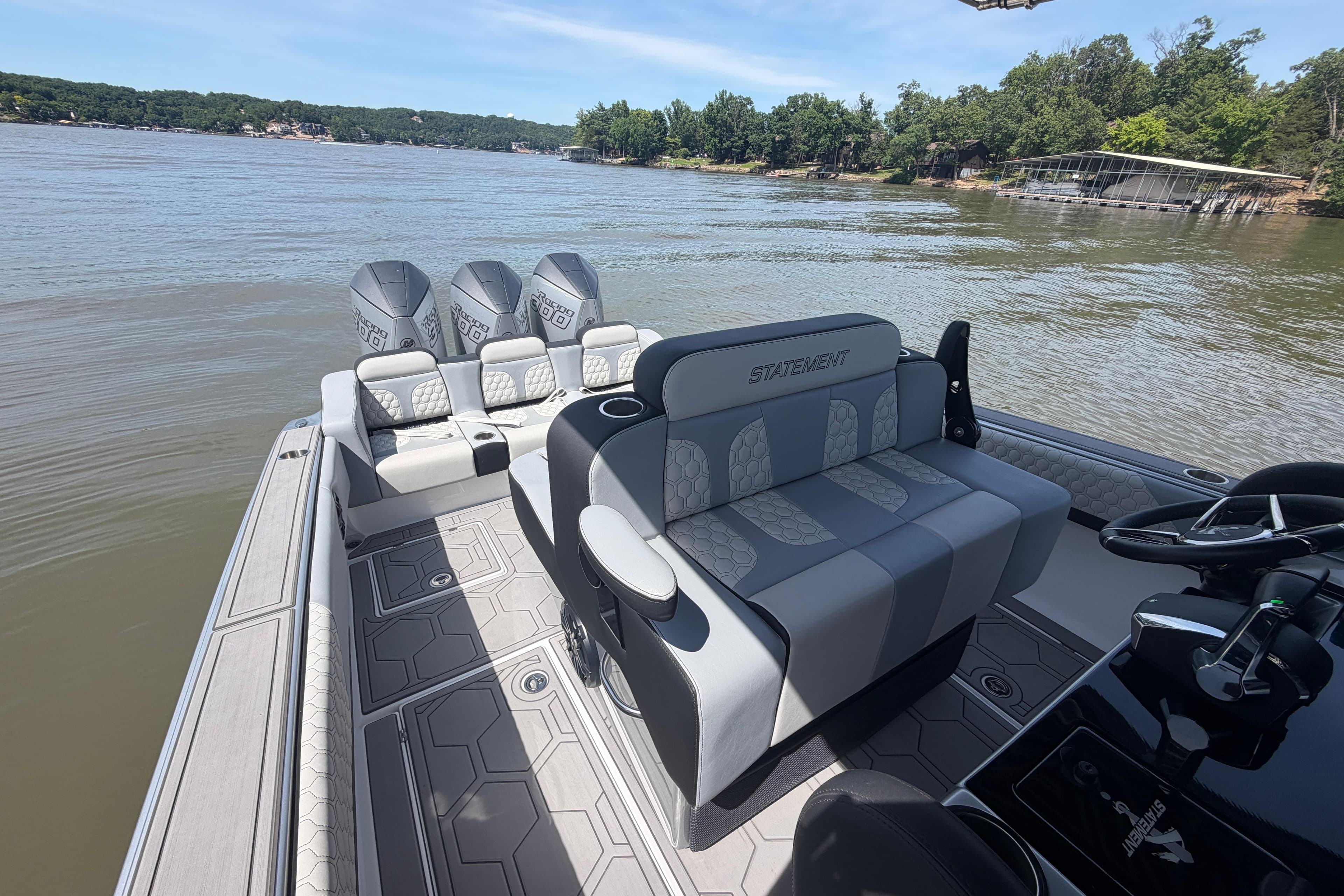 2024 Statement 350 Open boat interior with luxurious seating on a calm lake.