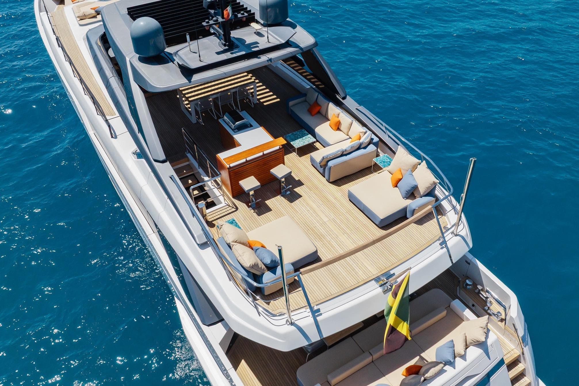 Luxurious 2022 Sanlorenzo SL106A yacht with spacious deck and elegant seating on blue ocean.