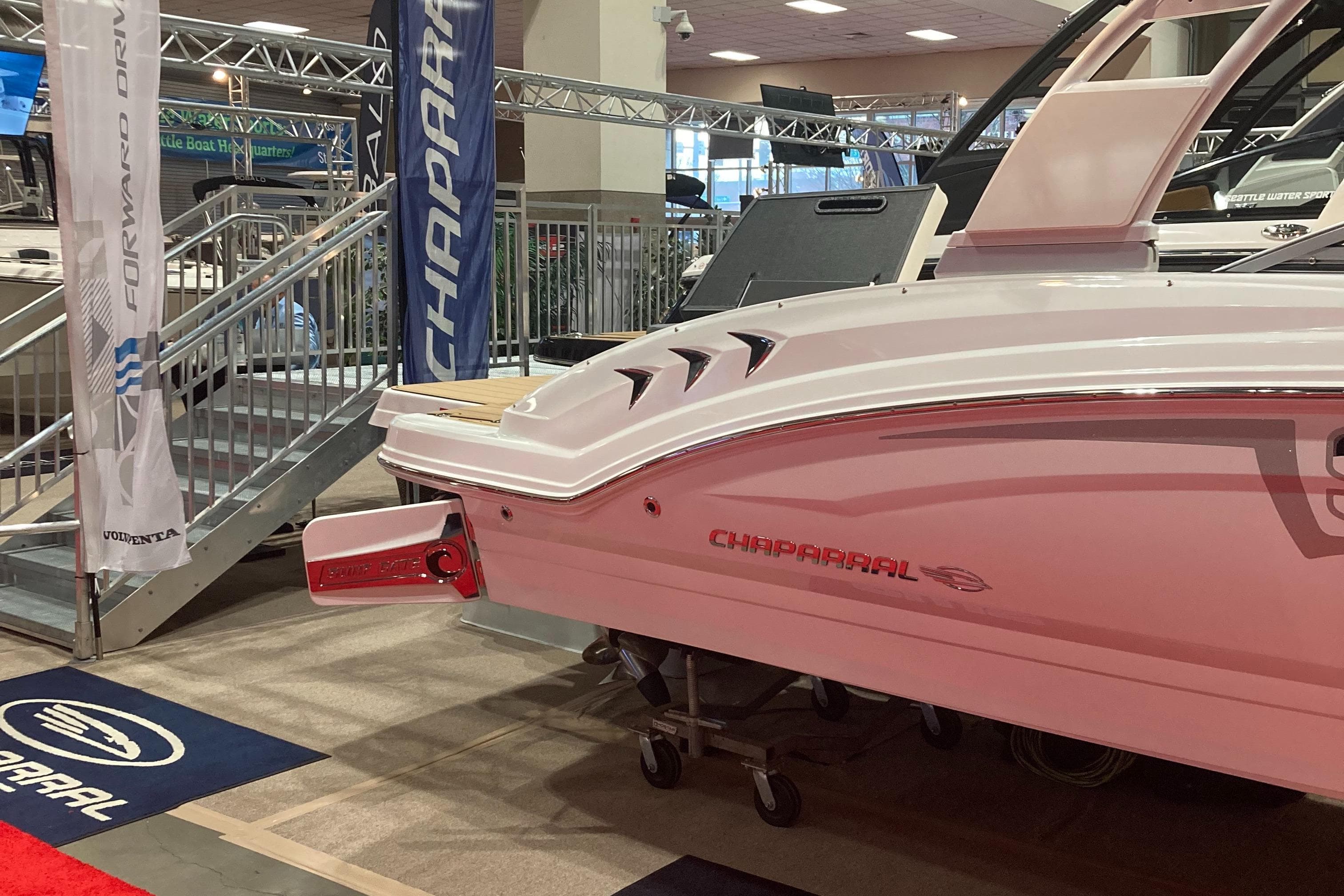 2024 Chaparral 23 Surf boat displayed at an indoor boat show.