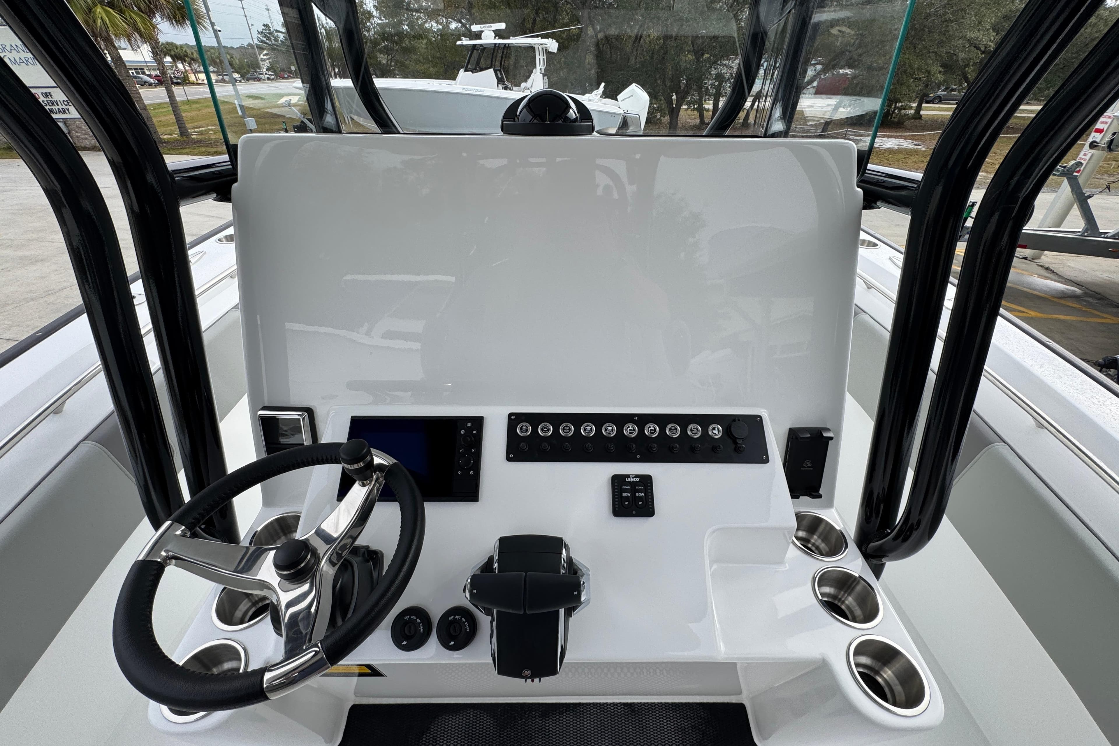 2026 Cape Horn 32 XS boat dashboard with steering wheel and control panel.