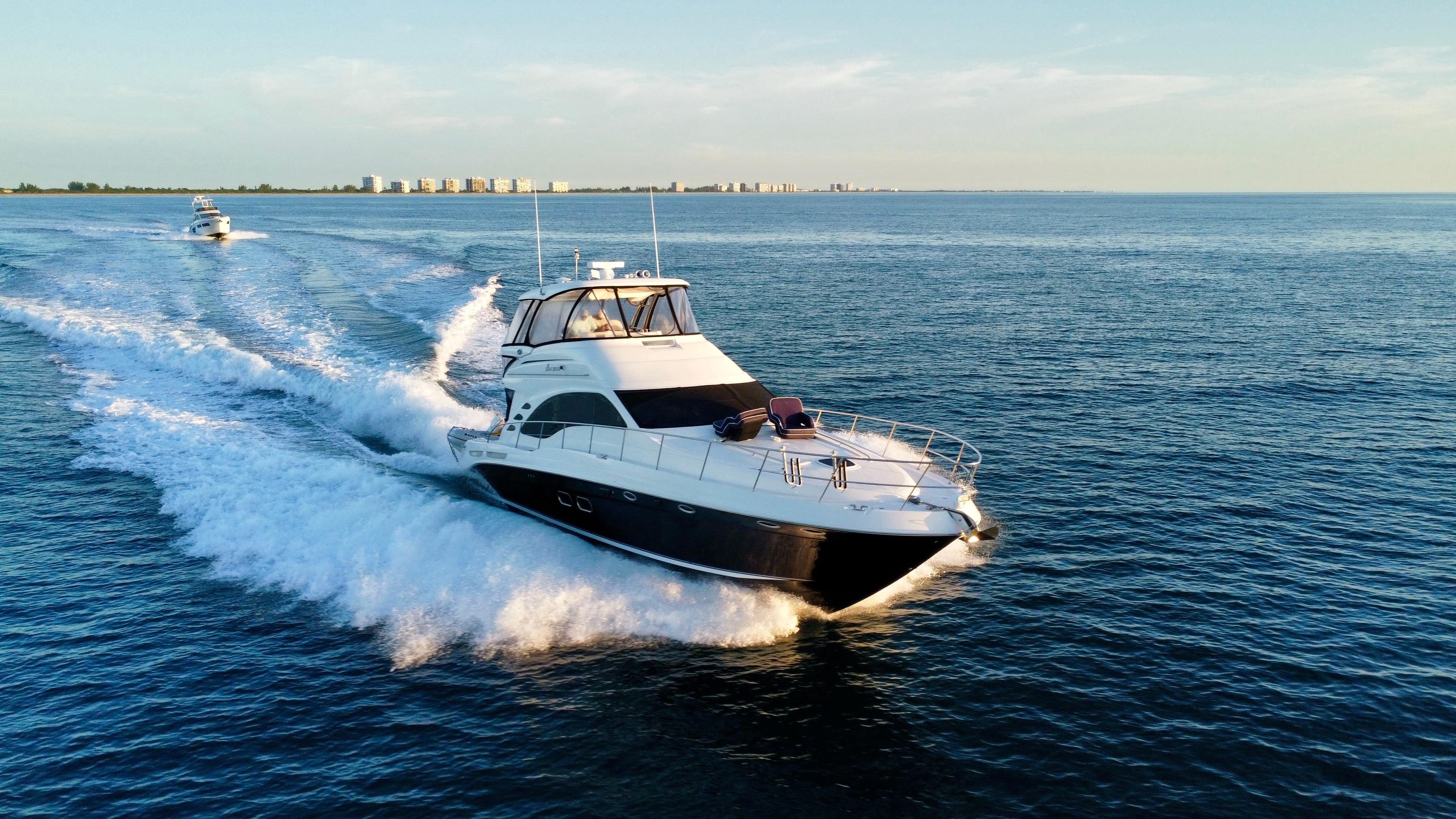 2008 Sea Ray 58 Sedan Bridge yacht cruising on open water at sunset.