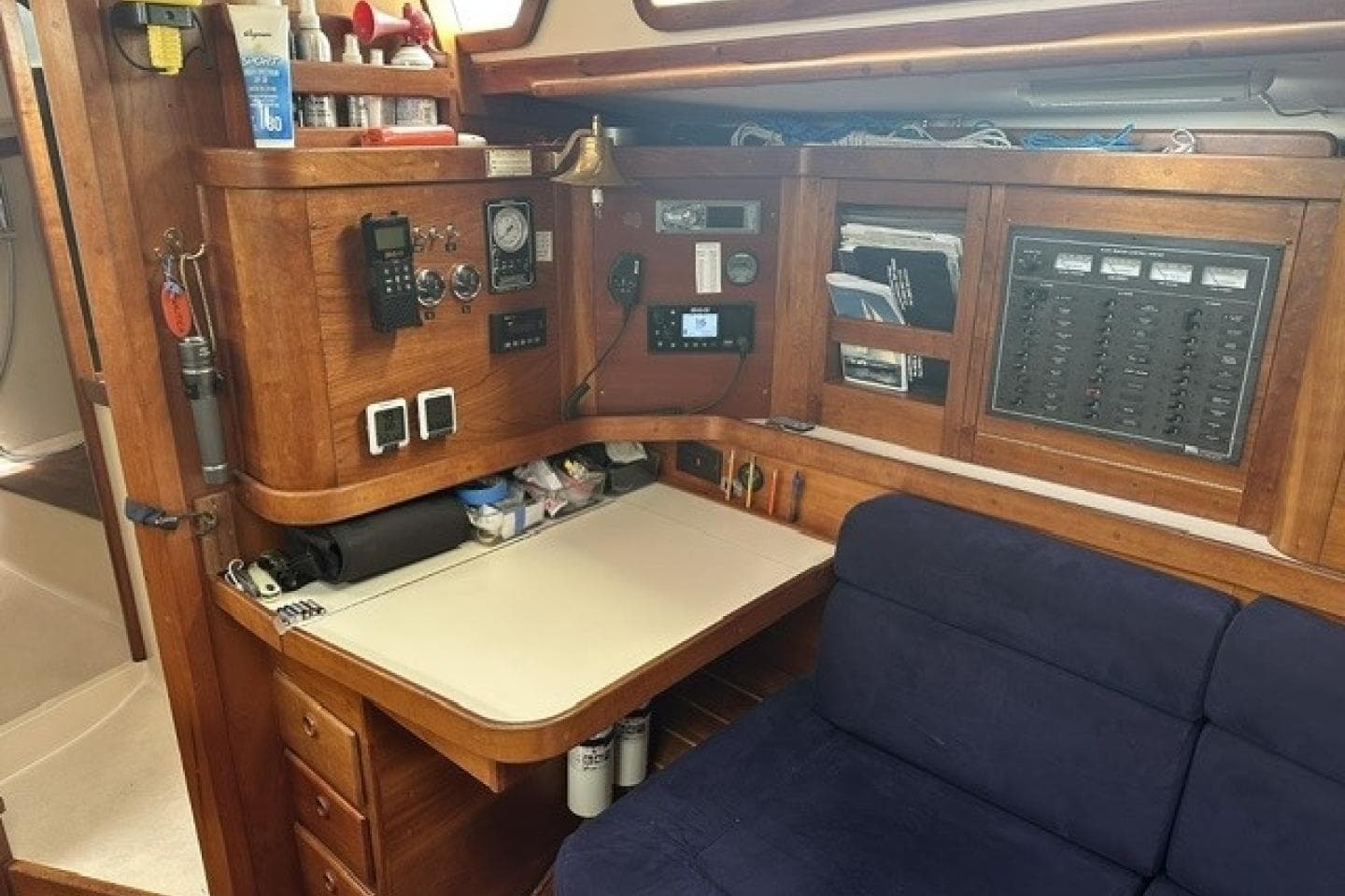 Navigation station in a 1994 Sabre 362 sailboat with control panels and seating.