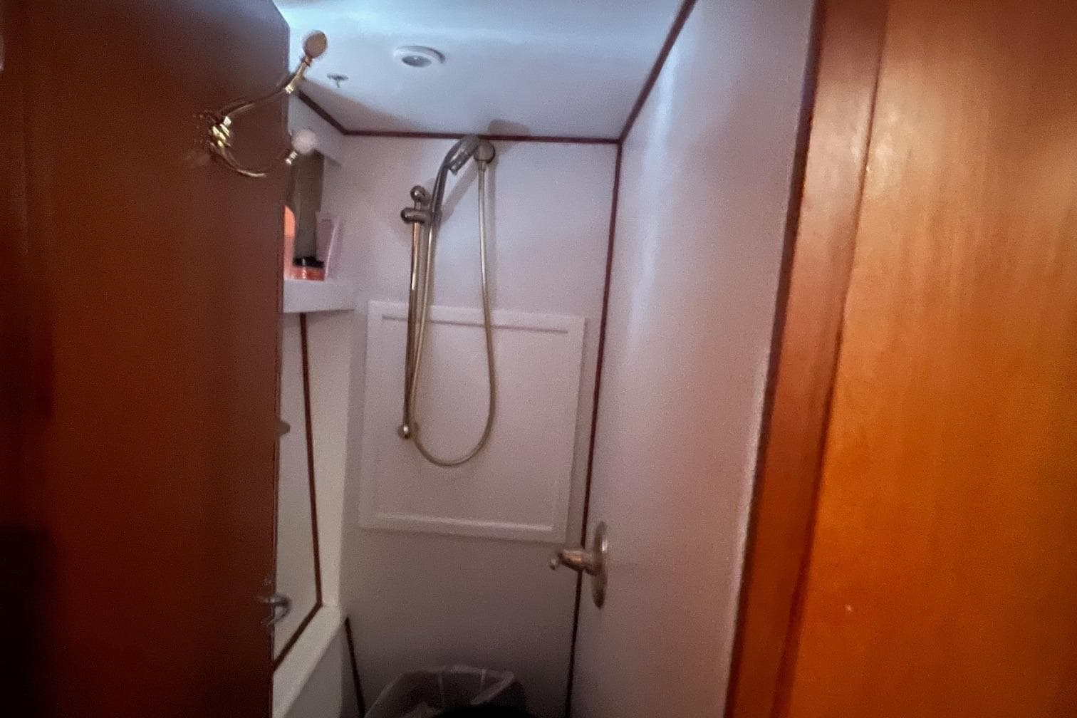 Bathroom interior of 1999 Jefferson Marquessa 56 yacht with shower and wooden door.