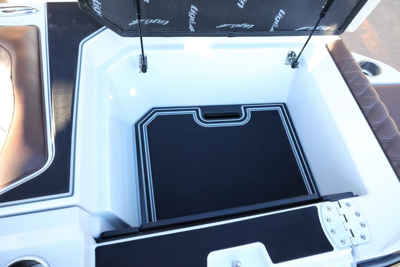 2026 Tigé 24RZX boat storage compartment with cushioned seating and sleek design.