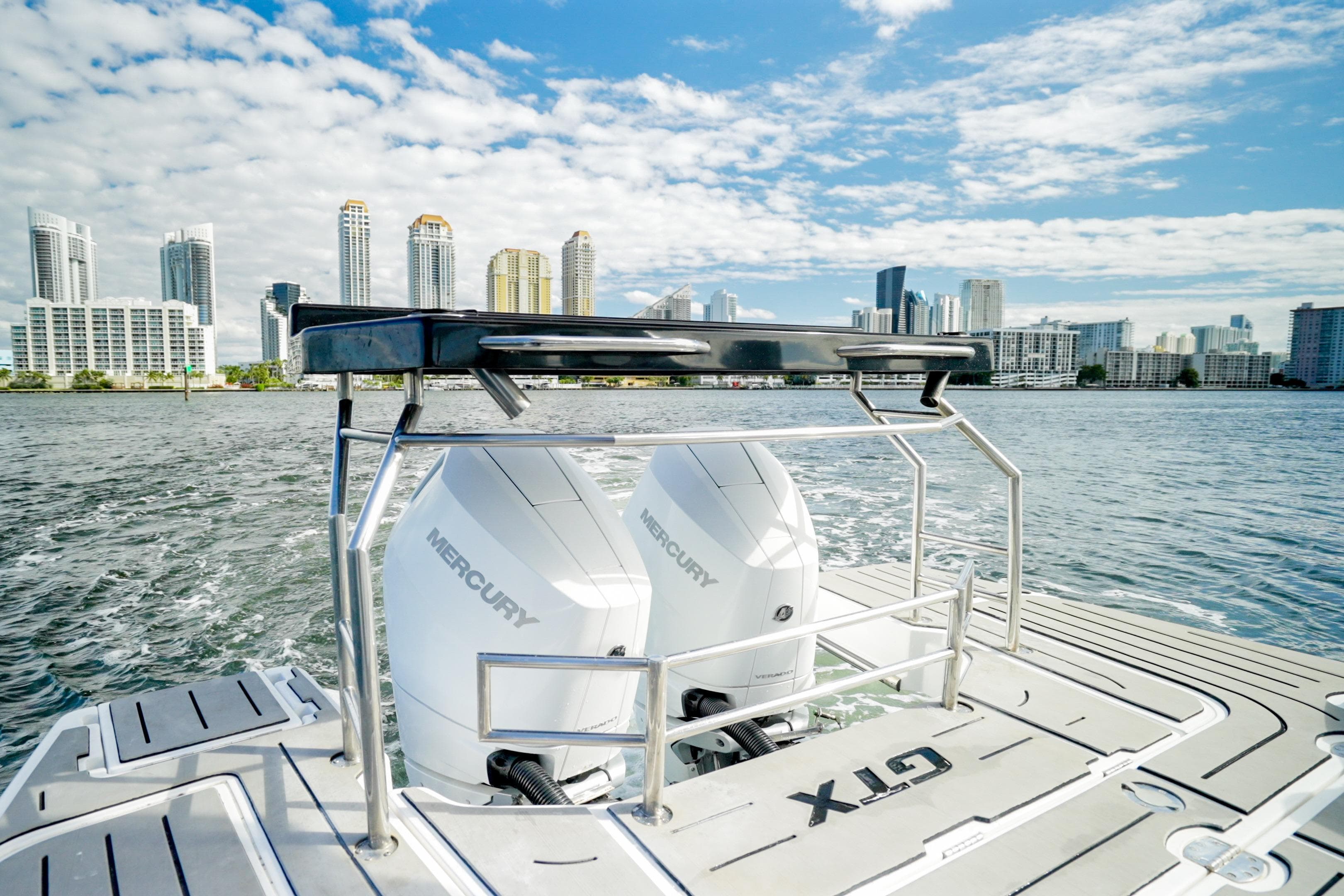 Granfort 370 GTX 2026 boat with Mercury engines, city skyline in background.