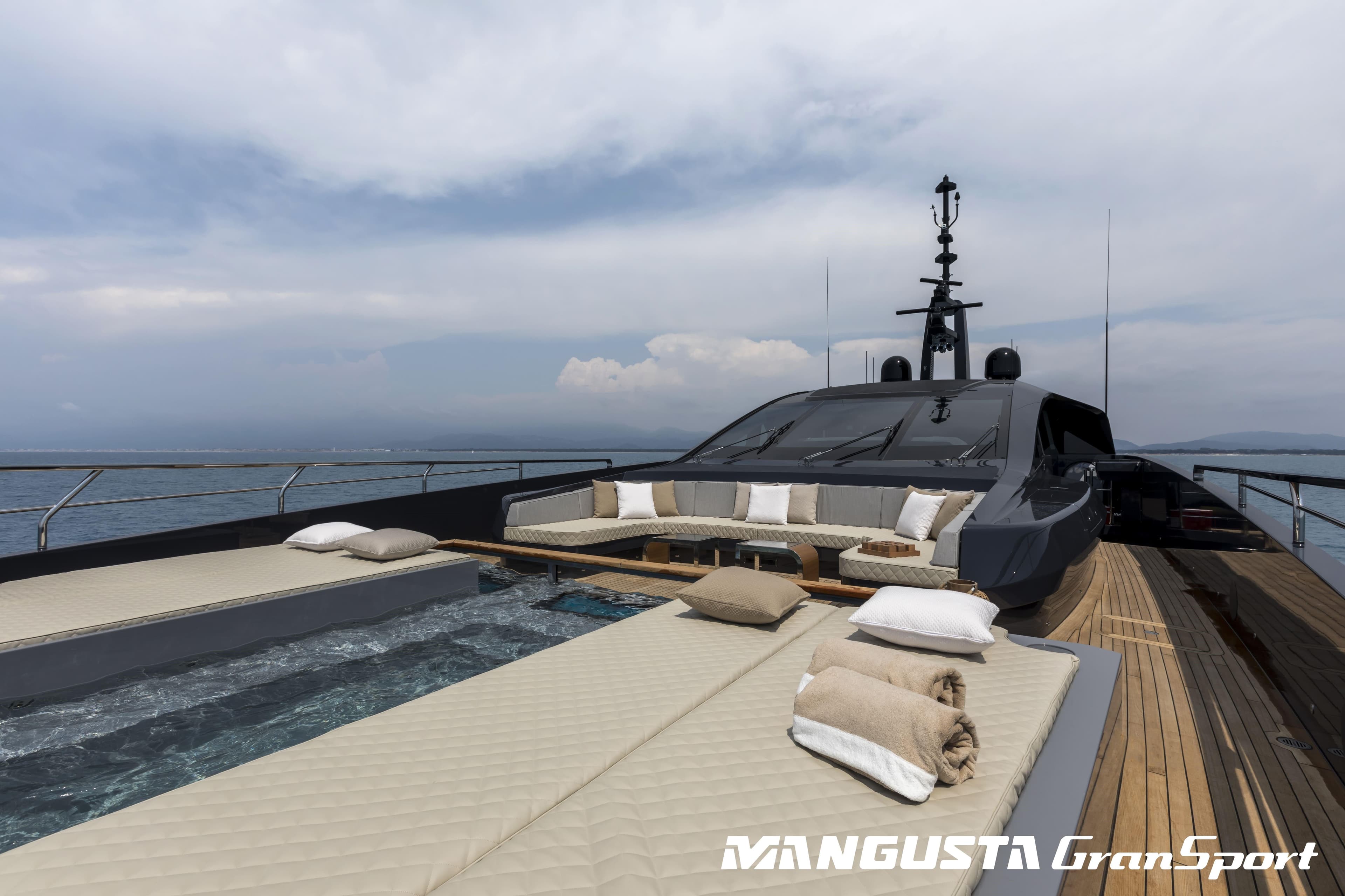 Luxury Mangusta GranSport 45 yacht deck with sunbeds and cushions, 2021 model.
