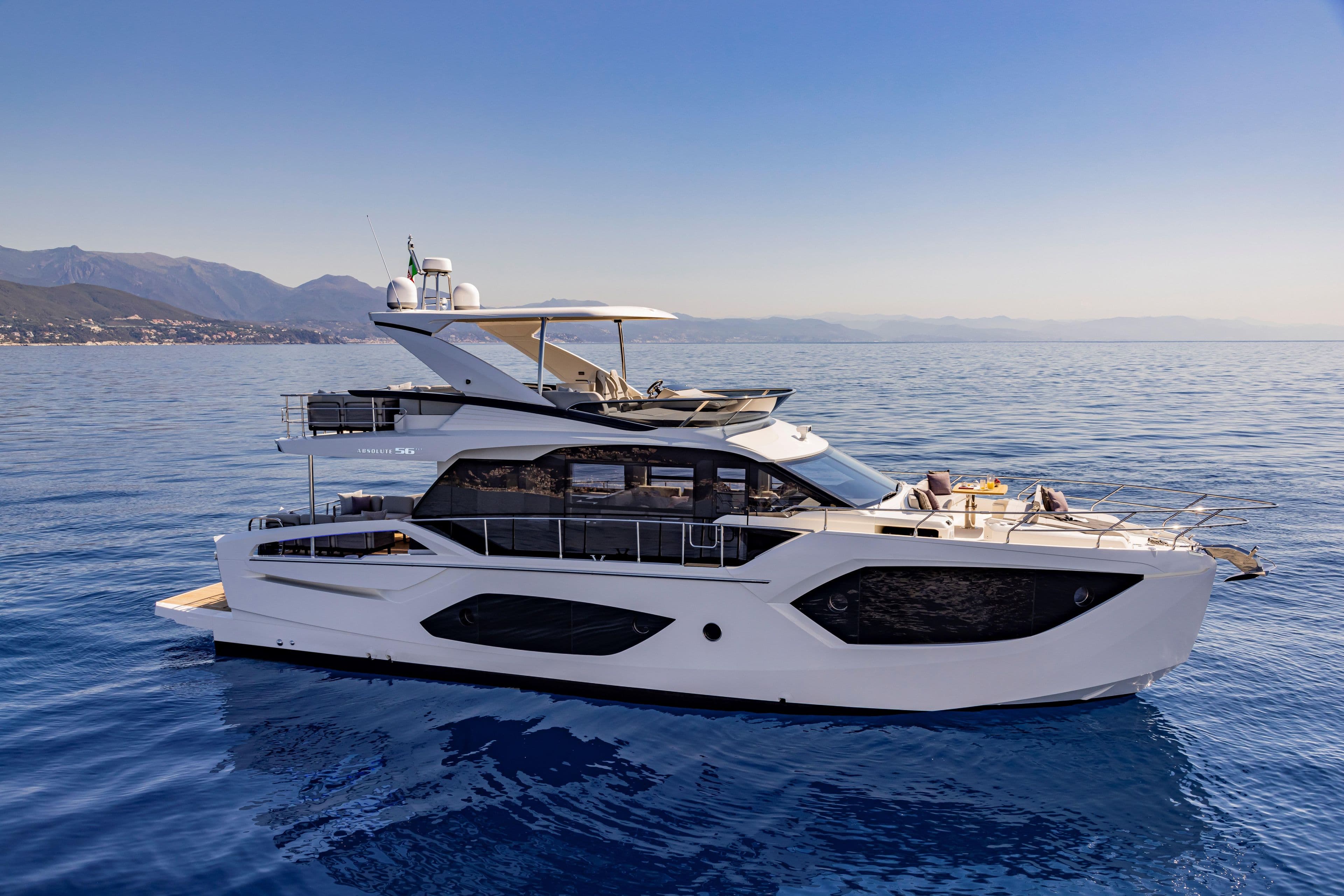 Luxurious 2025 Absolute 56 FLY yacht cruising on serene blue waters.