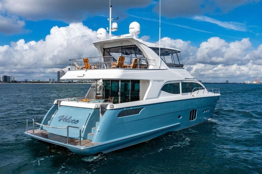 Luxurious 2013 Lanzarote Ventuno 73 yacht cruising on open water under a cloudy sky.