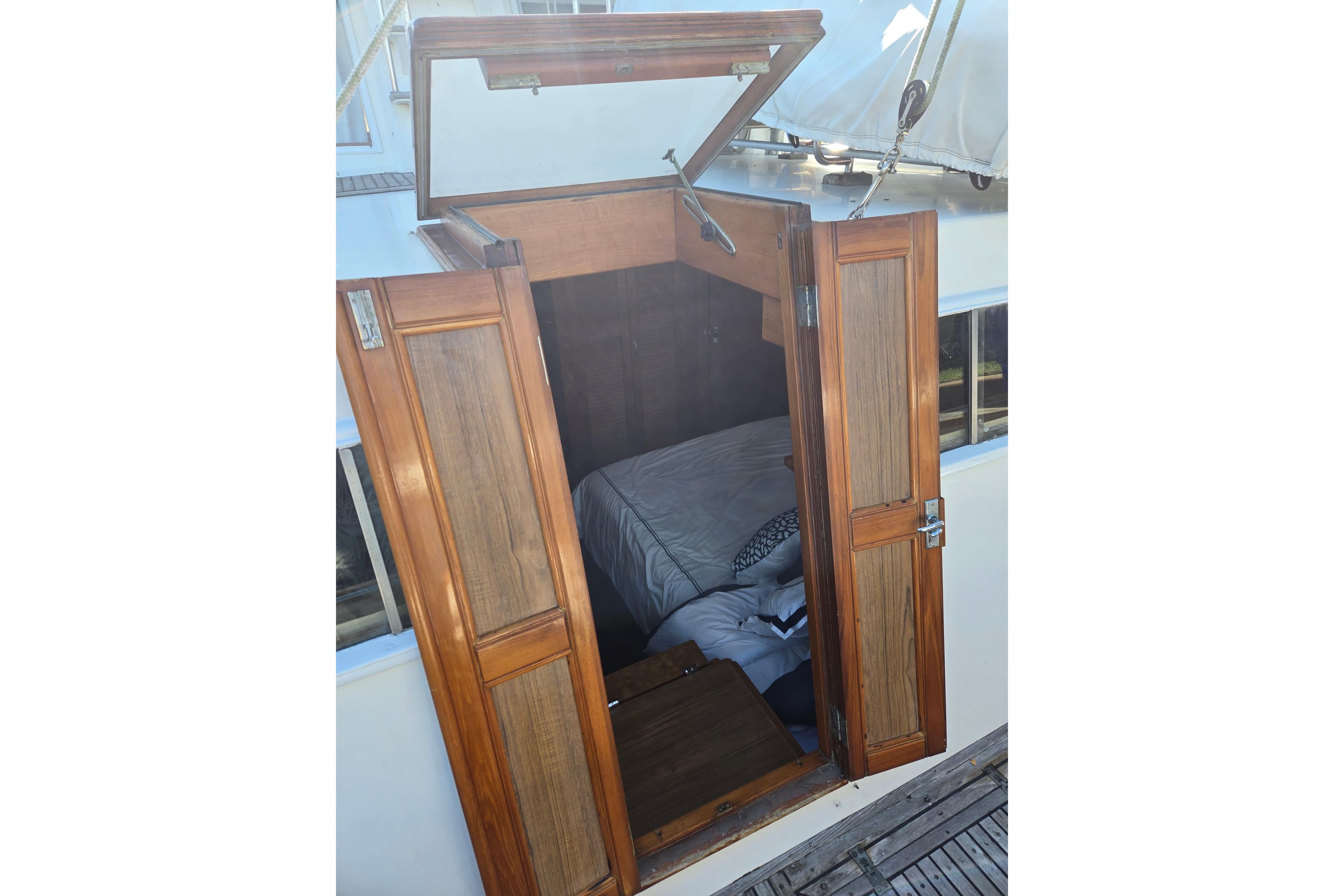 Wooden cabin entrance of 1992 Grand Banks 46 Classic yacht, showing interior bedding.