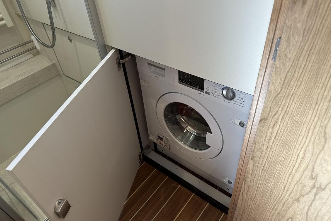 Washing machine in Linssen Grand Sturdy 550 Variotop yacht, 2026 model, wooden flooring.