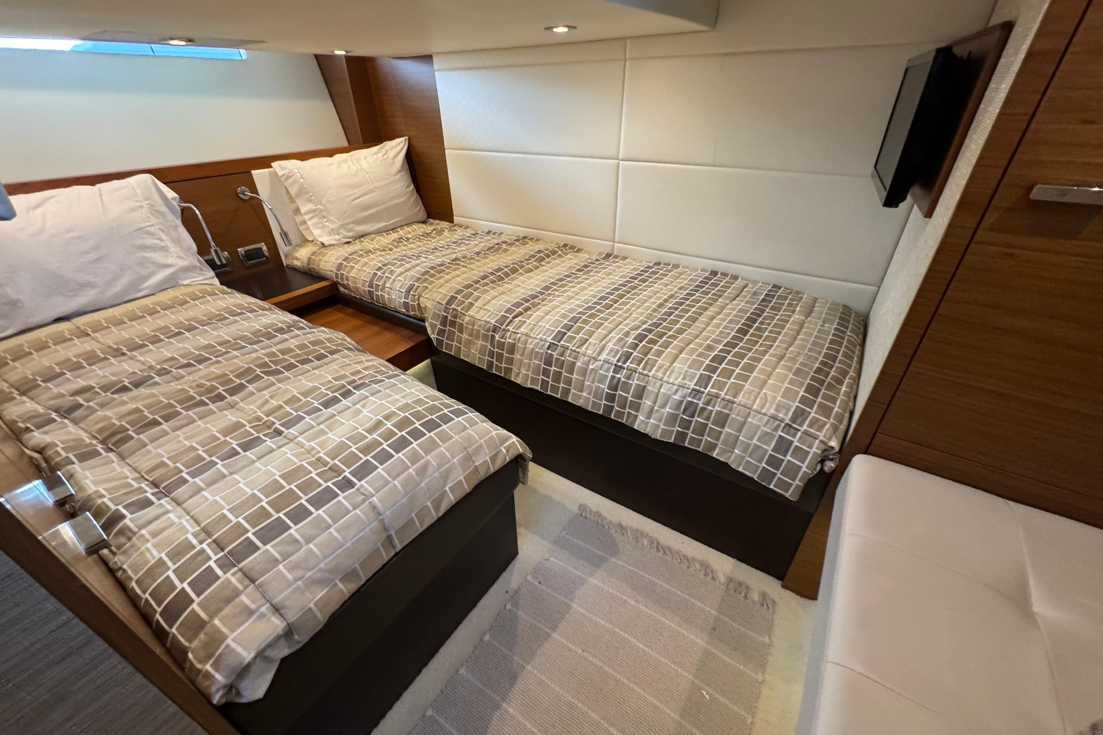 2016 Tiara Yachts C44 Coupe cabin with twin beds and modern decor.
