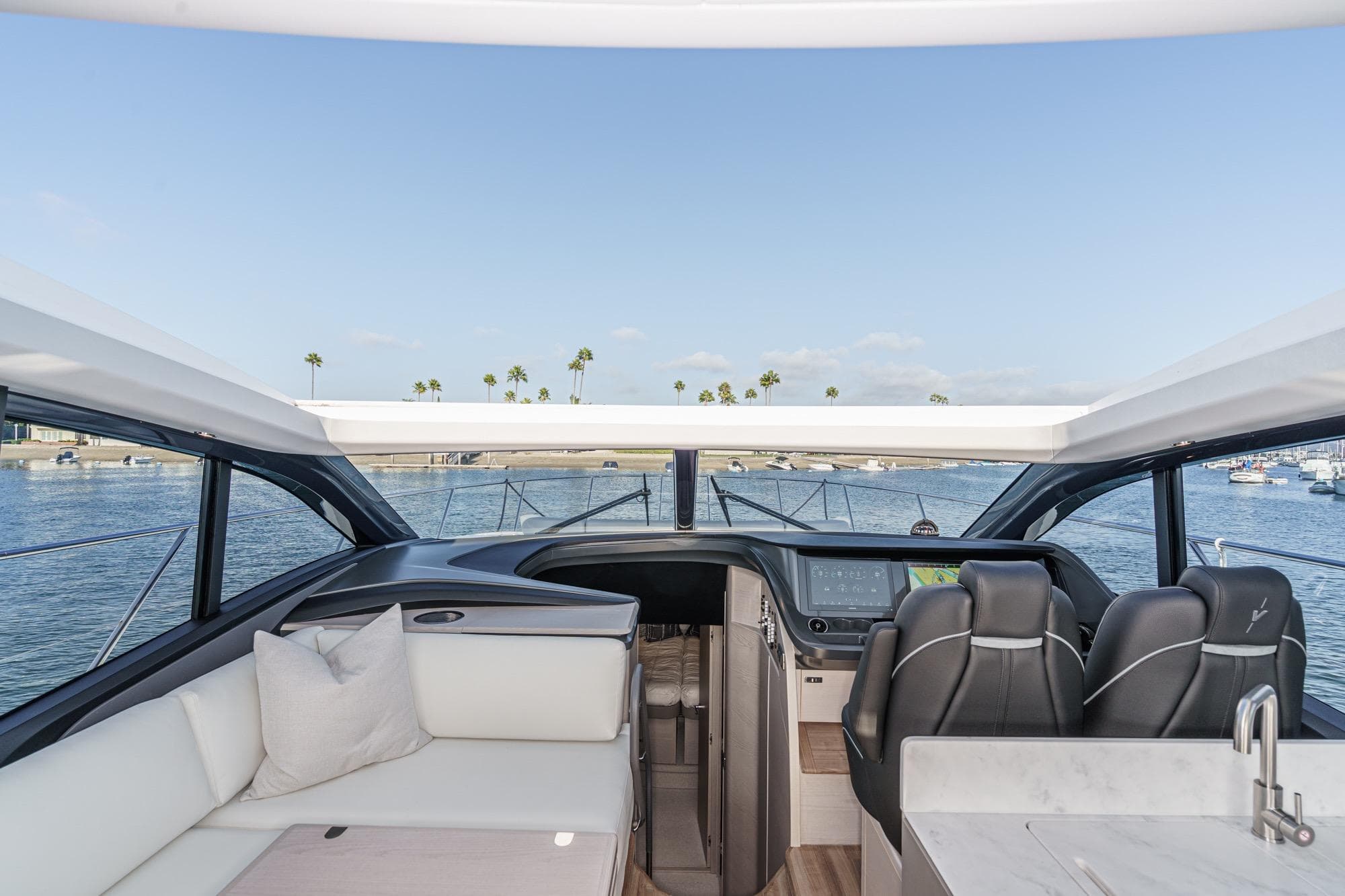 Interior view of 2026 Princess V55 yacht with luxurious seating and modern helm.
