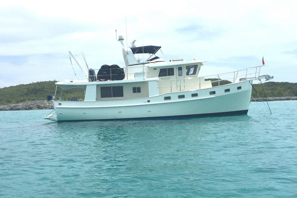 2011 Kadey-Krogen 48 AE yacht anchored in clear blue water.