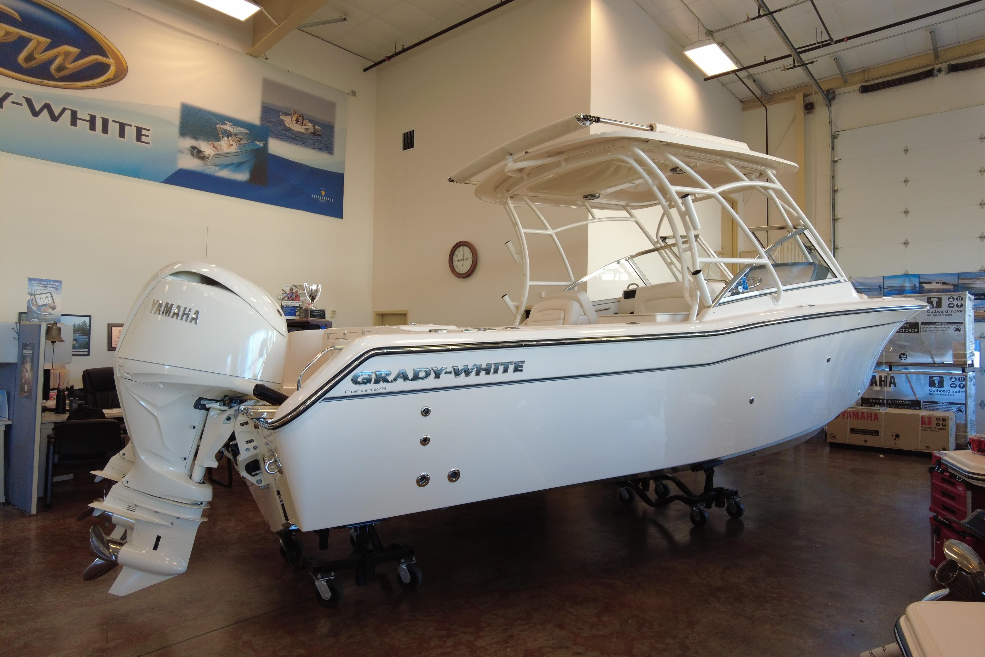 2025 Grady-White Freedom 275 boat displayed indoors with Yamaha engine.