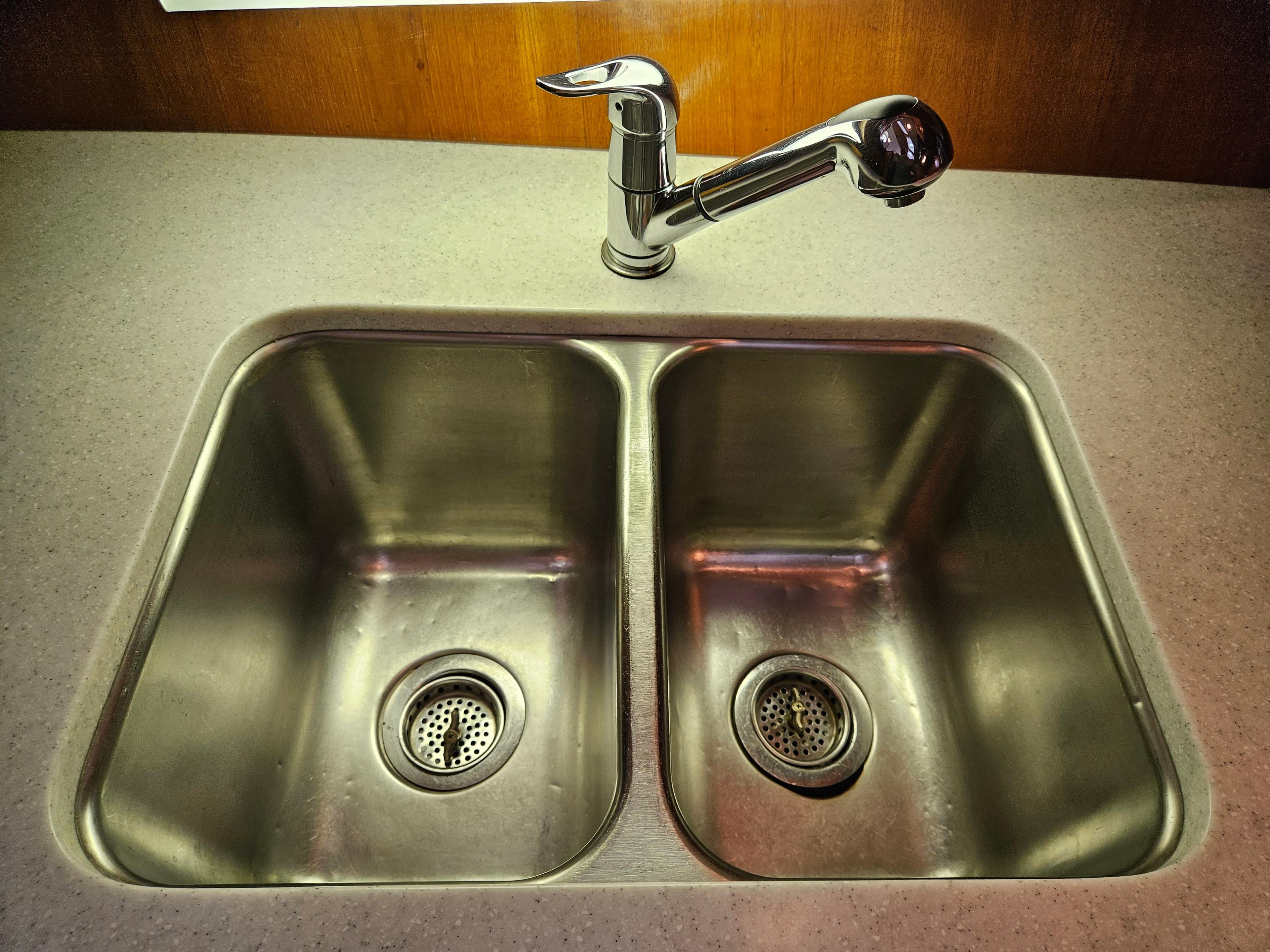 Stainless steel double sink with modern faucet on Ocean Alexander 43, 1983 model.