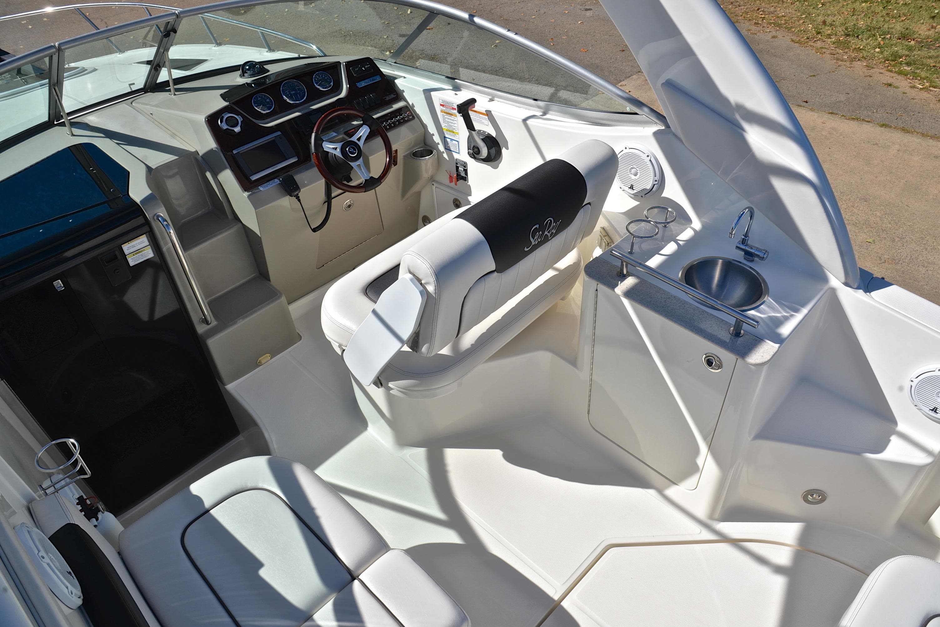 Interior of 2011 Sea Ray 260 Sundancer boat with helm, seating, and sink.