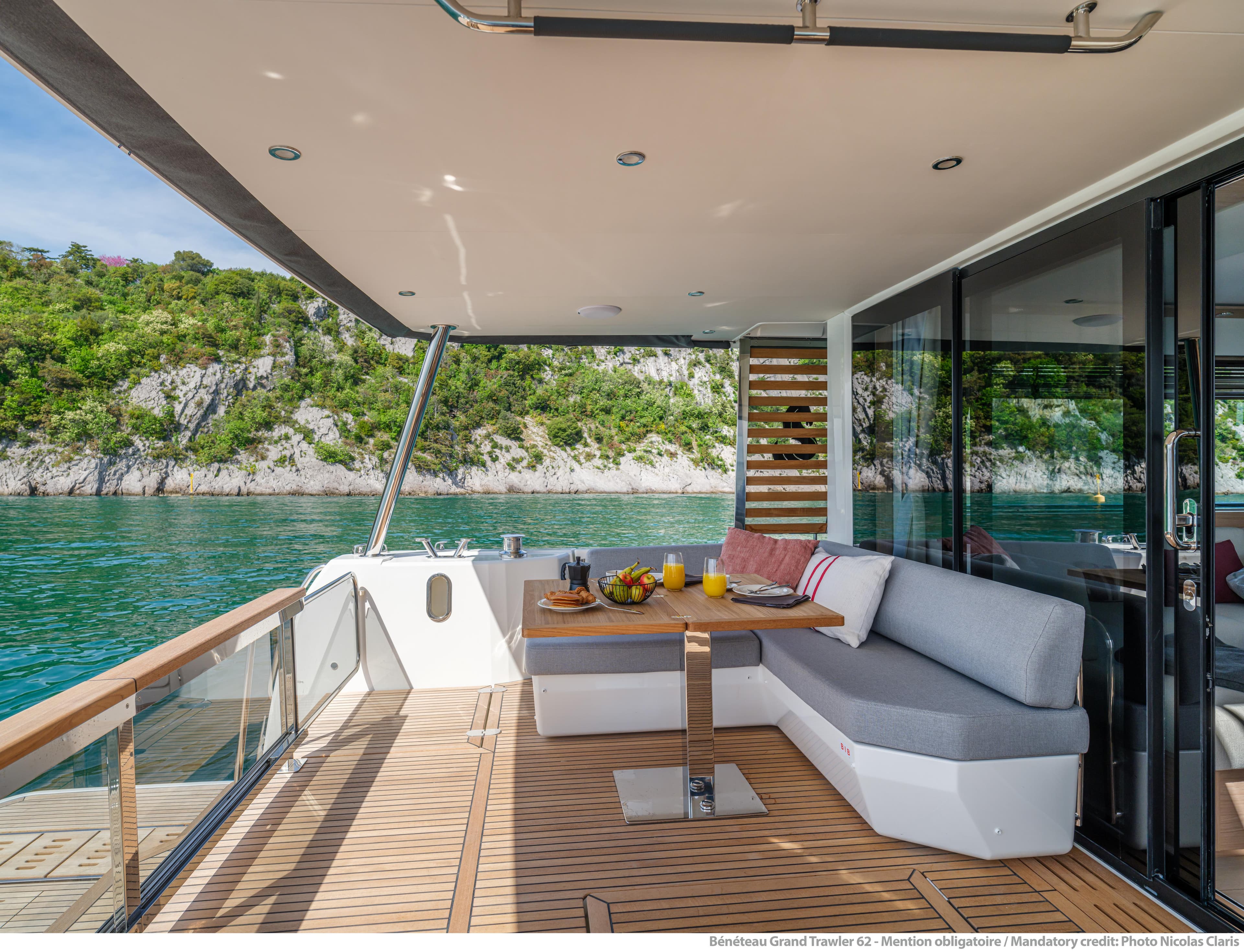 Luxurious 2025 Beneteau Grand Trawler 62 yacht deck with scenic water view.
