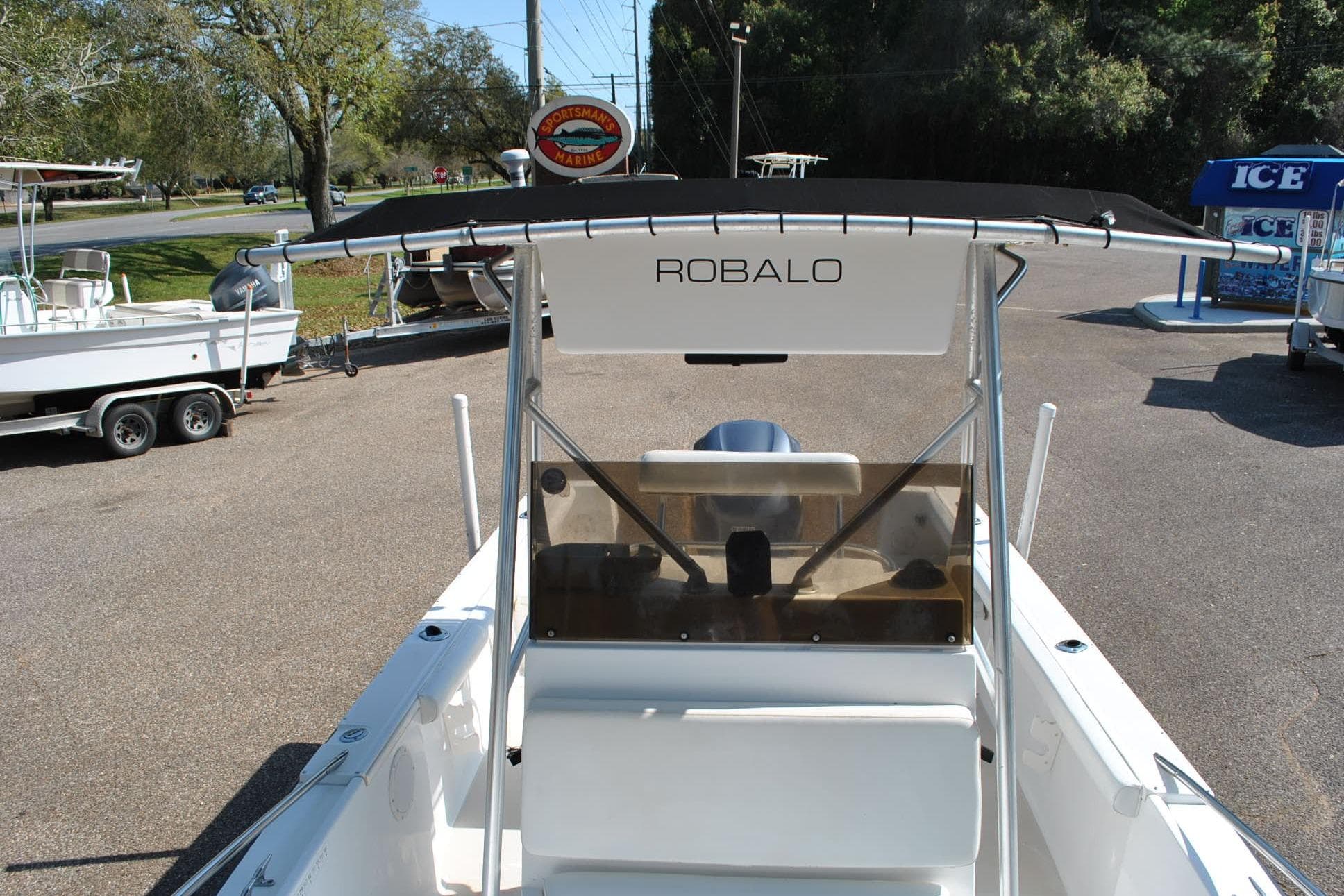 1993 Robalo 2120 Center Console boat with T-top, parked outdoors.