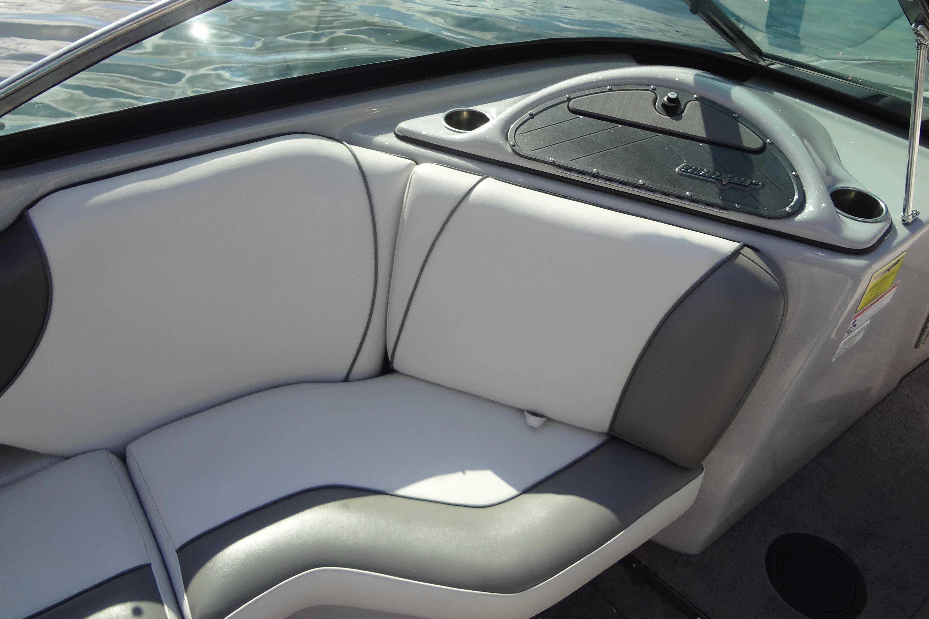 Interior seating of 2022 Sanger V237 S boat with gray and white upholstery.