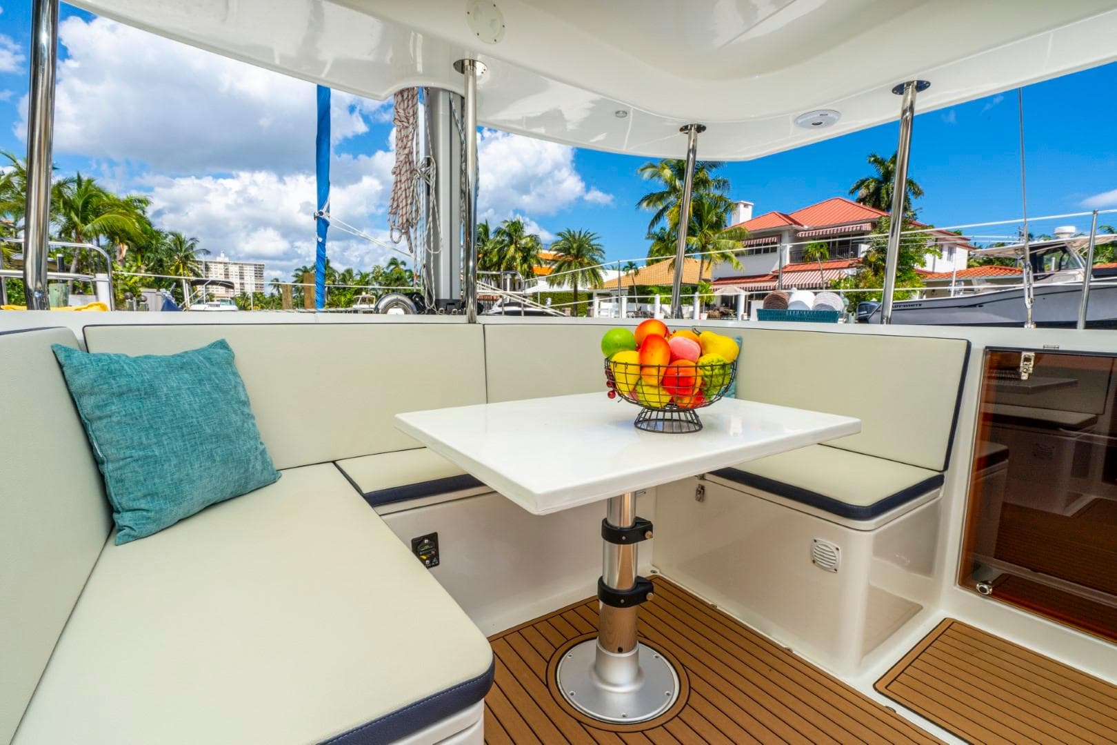 Luxurious seating area on 2025 Smart Cat E280 Electric yacht with fruit basket centerpiece.