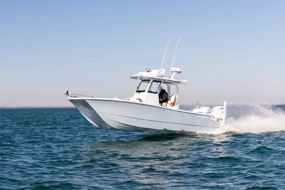 2026 Freeman 28 boat cruising on open water, clear sky background.