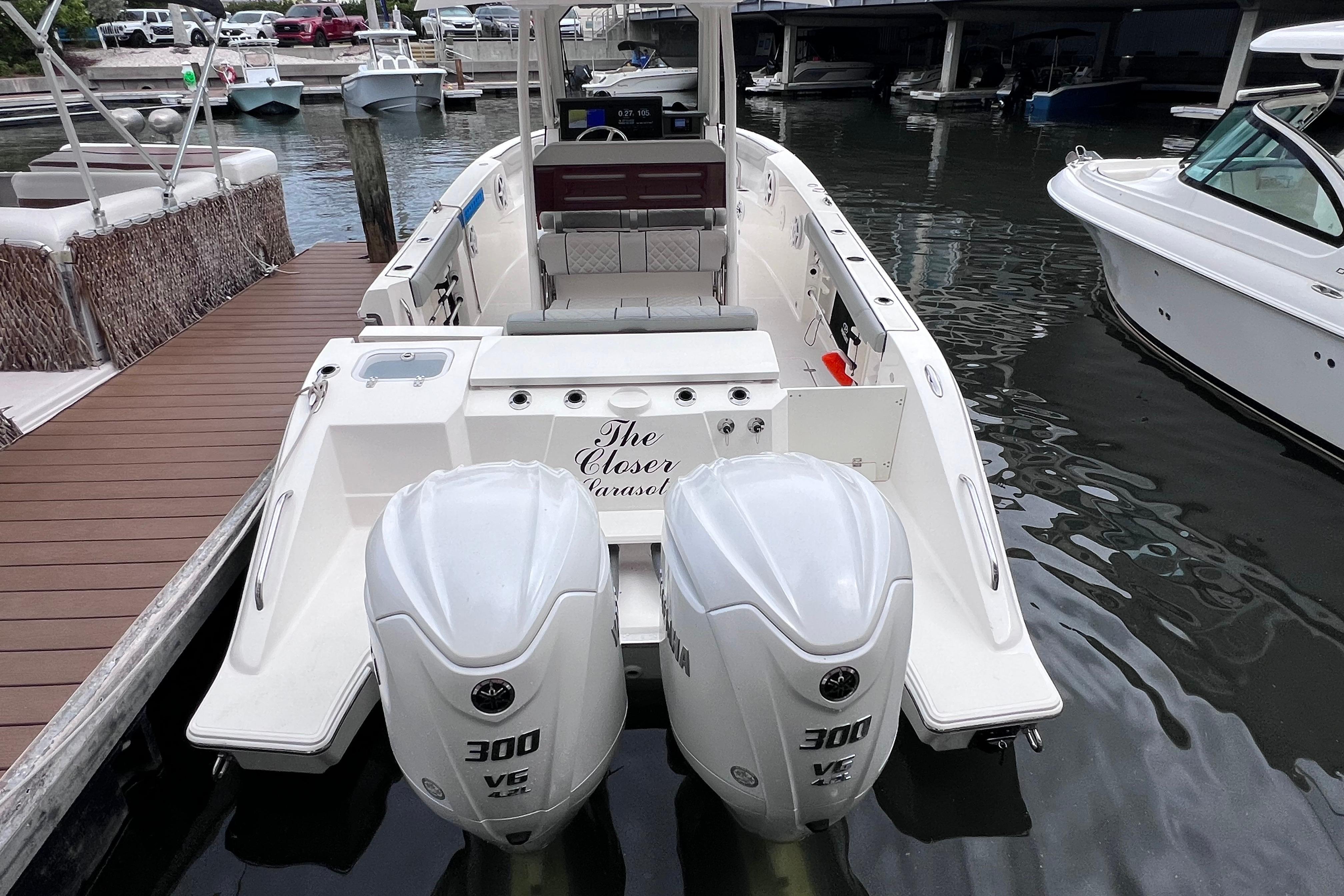 2022 Pursuit S 288 Sport boat docked with twin 300 V6 engines.