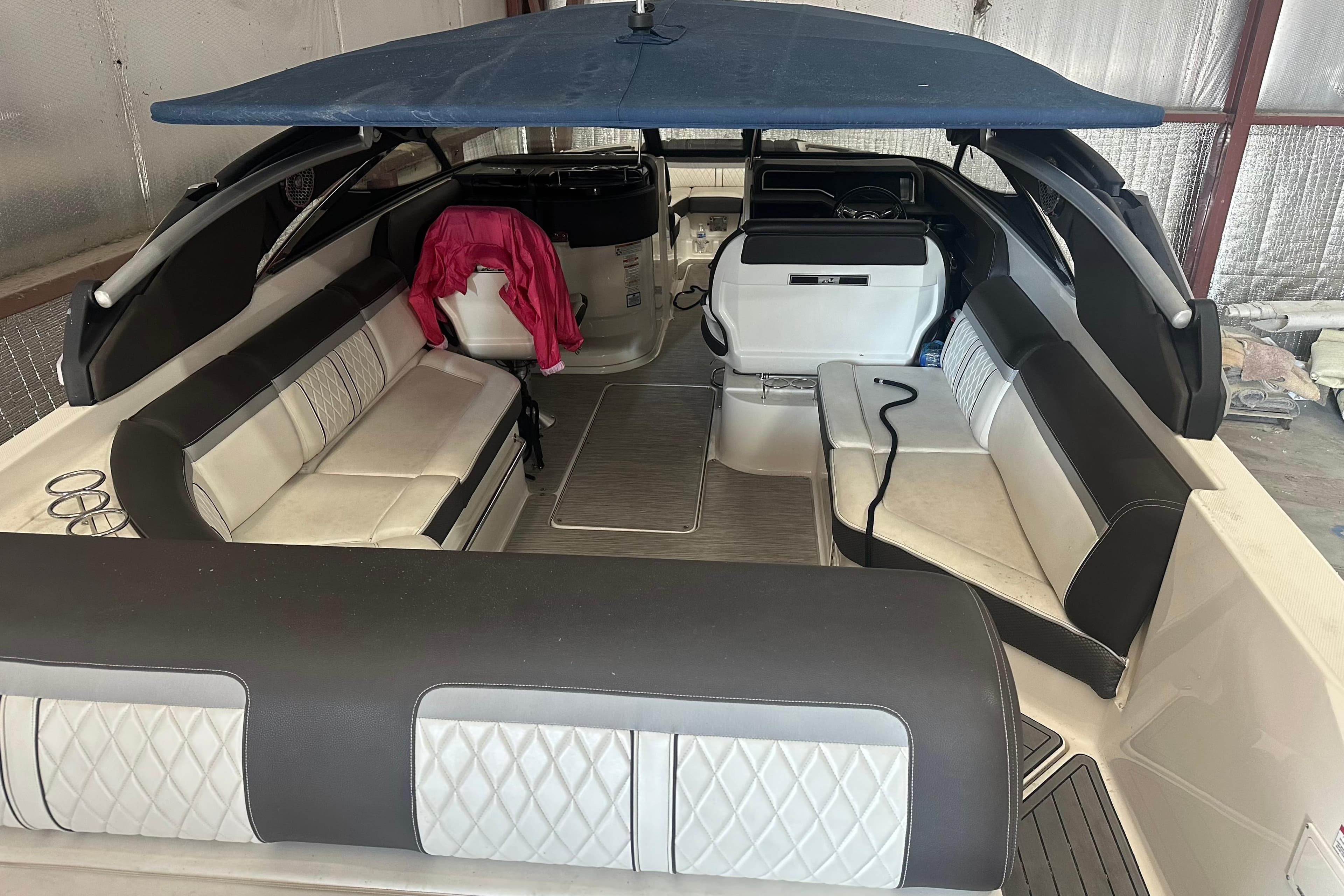 Interior of a 2017 Sea Ray SLX 280 with blue canopy.