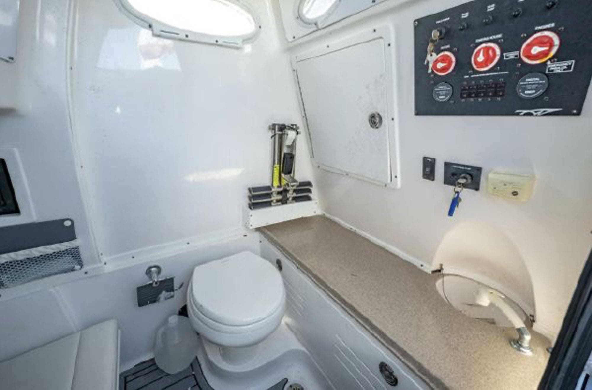2020 Tidewater 320 CC Adventure boat interior with toilet and control panel.