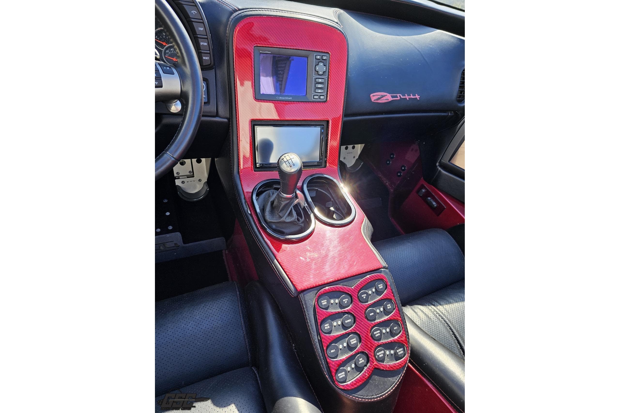 2010 MTI 44 Corvette interior with red carbon fiber console and manual gear shift.