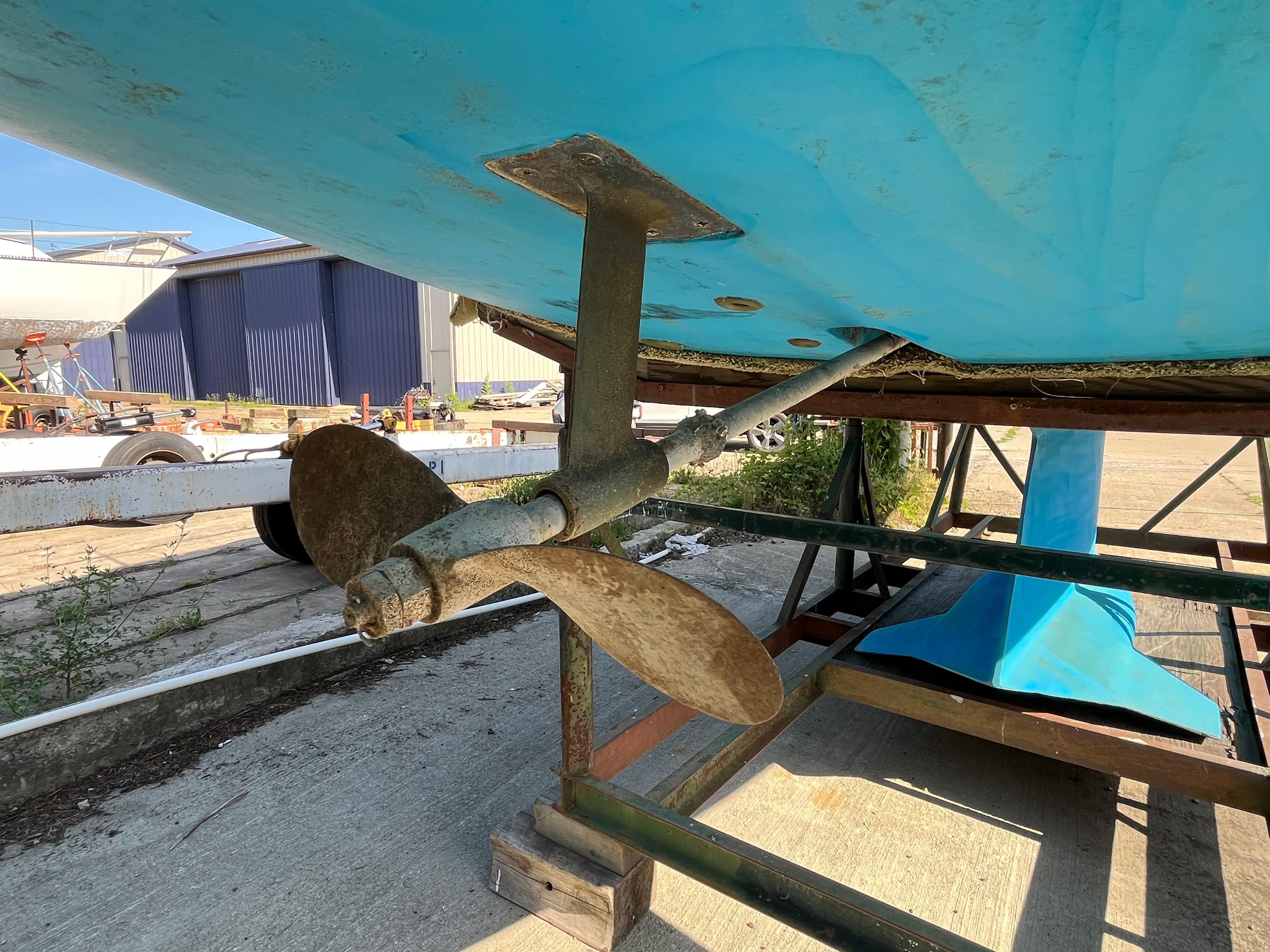 Propeller and rudder of a 1992 Hunter 30-2 sailboat on a stand.