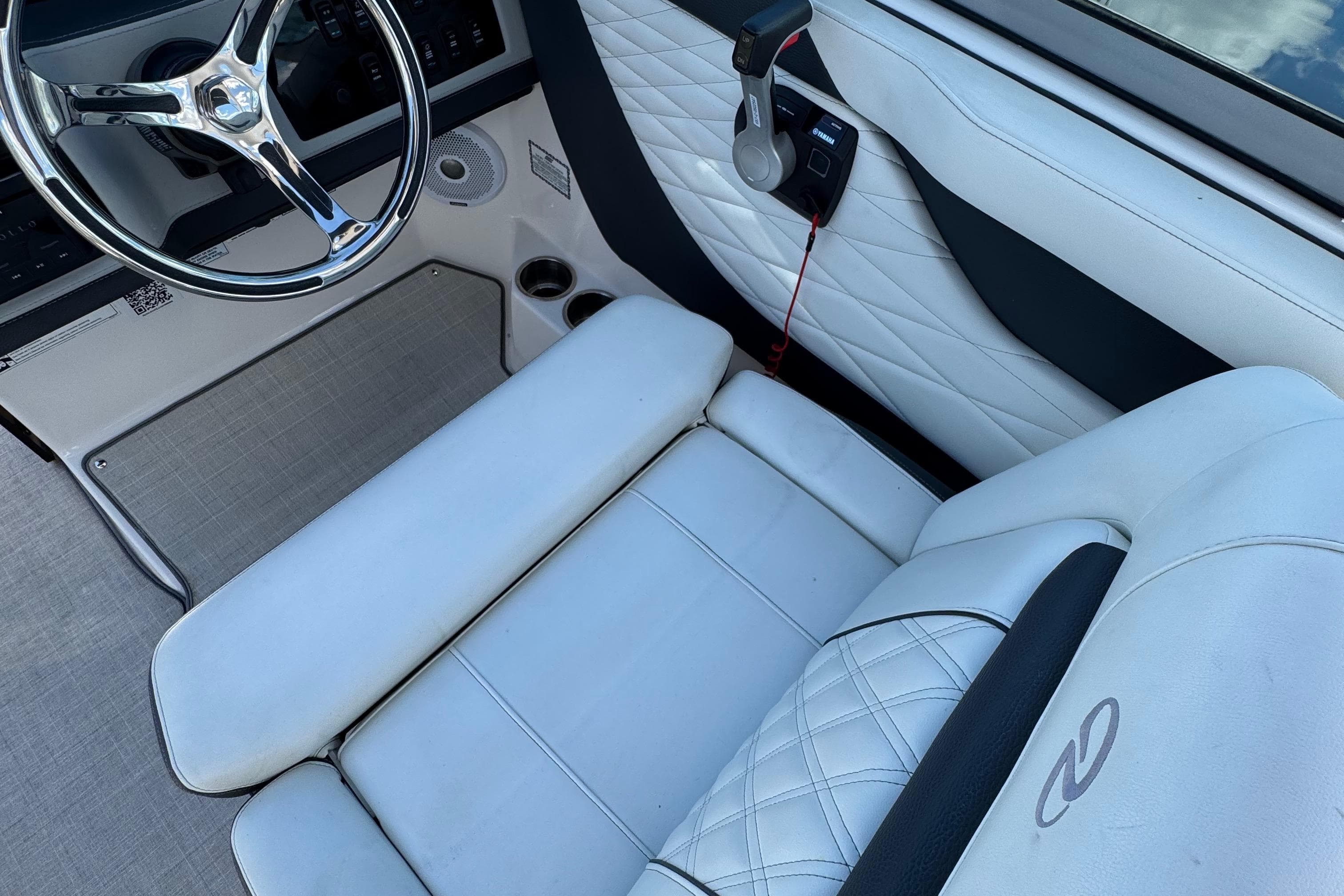 2021 Regal 26 OBX boat interior with white leather seating and steering wheel.